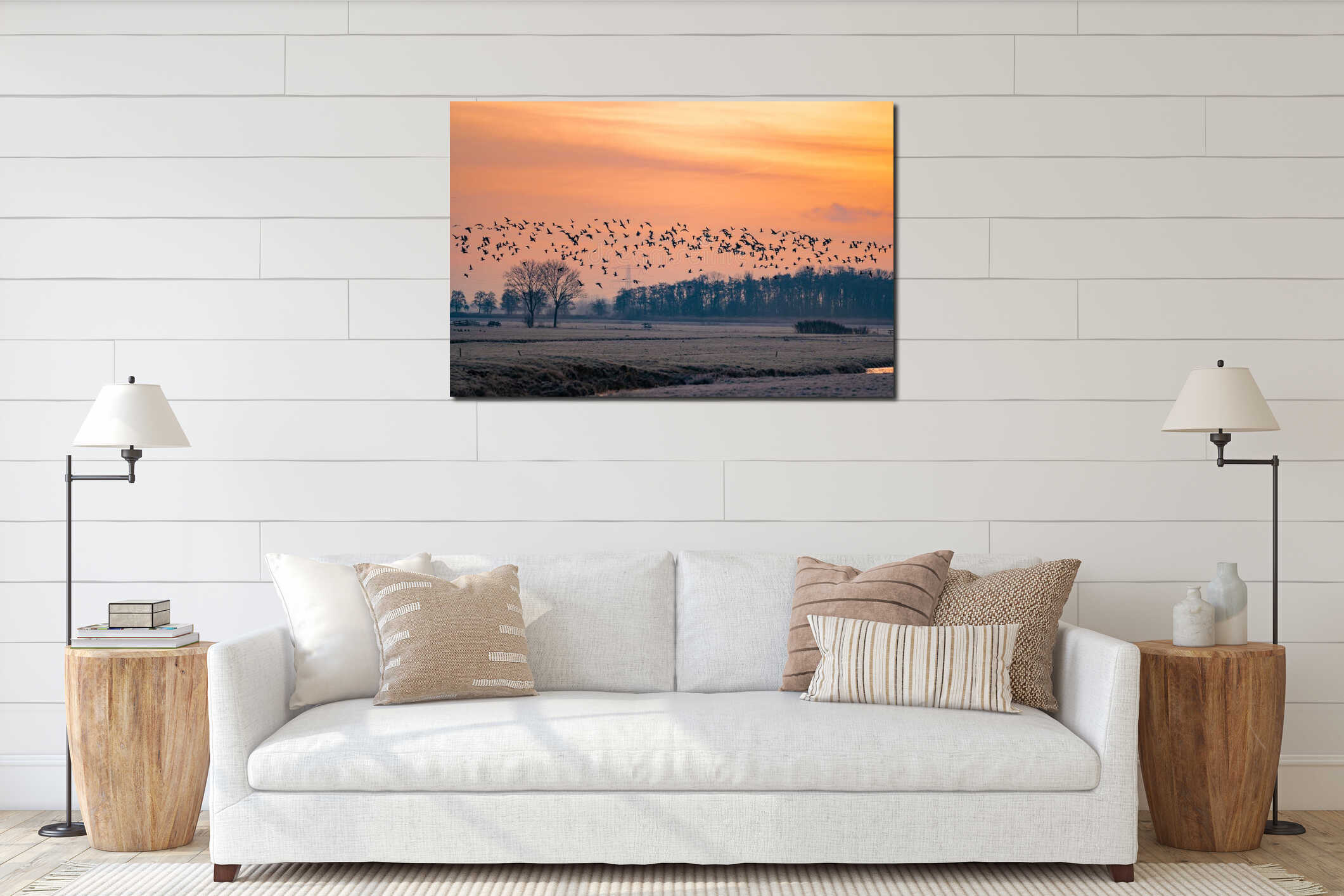 Silhouettes of wild geese flying in flock early morning before sunrise on a bright red colored sky interior mockup