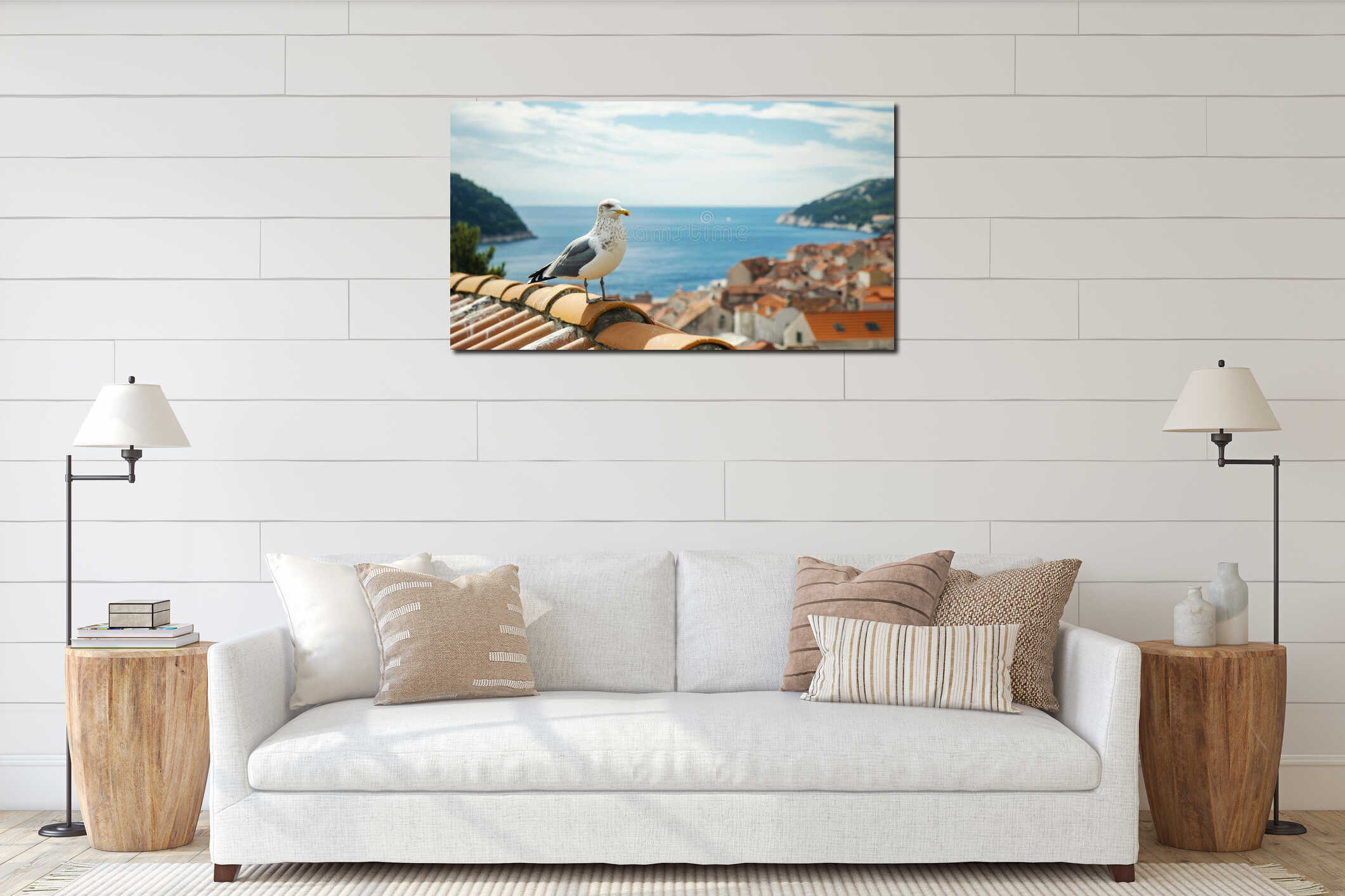 Seagull perched on rooftop overlooking coastal town, sea and mountains in background, sunny day, travel and nature interior mockup