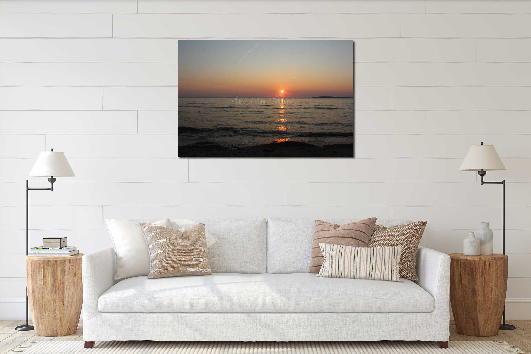 A sunset over a beach with gentle waves and an airplane and island in the distance, a clear summer evening interior mockup