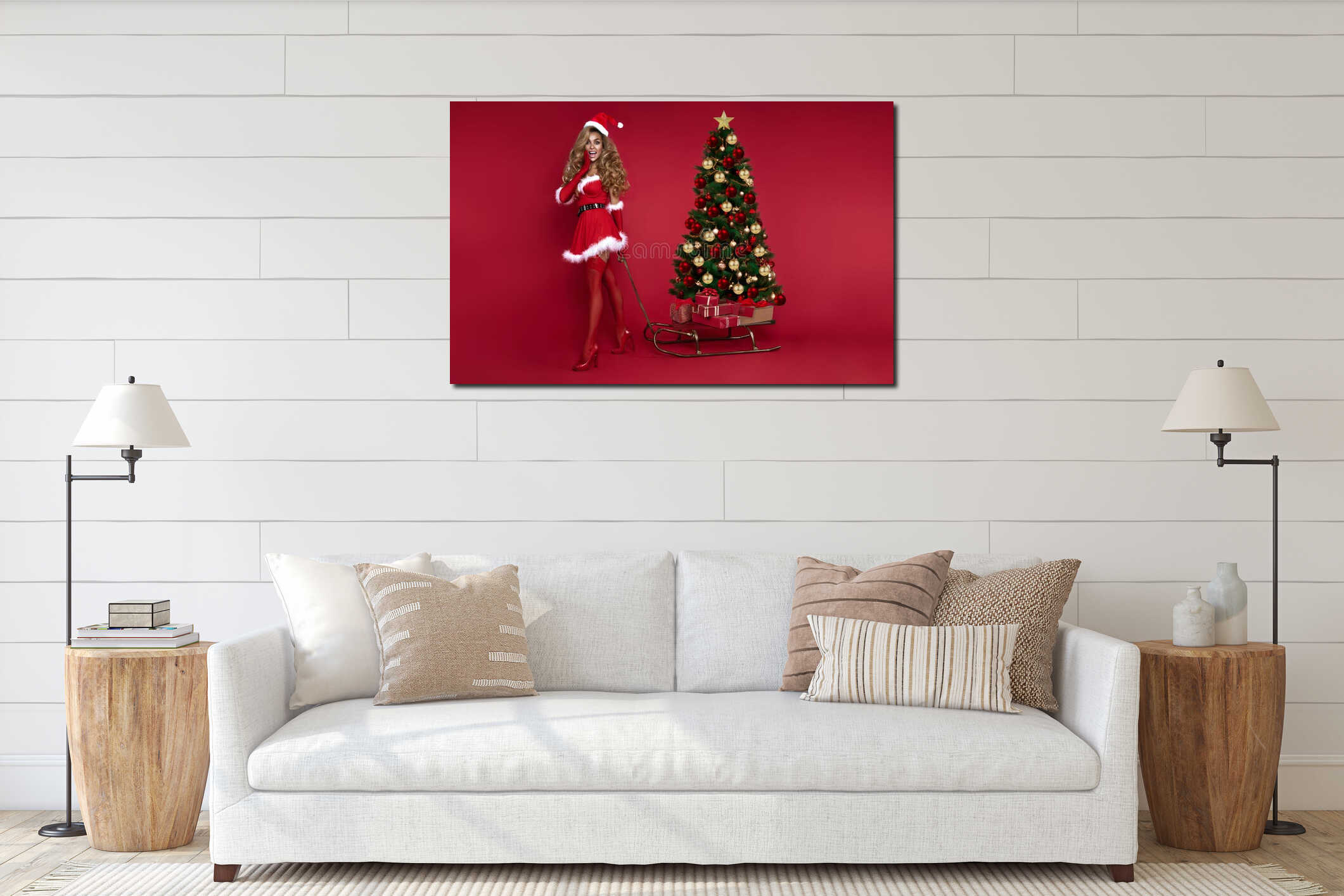 Cheerful girl wearing red sexy Santa Claus costume holding sleigh with Christmas tree on red background interior mockup