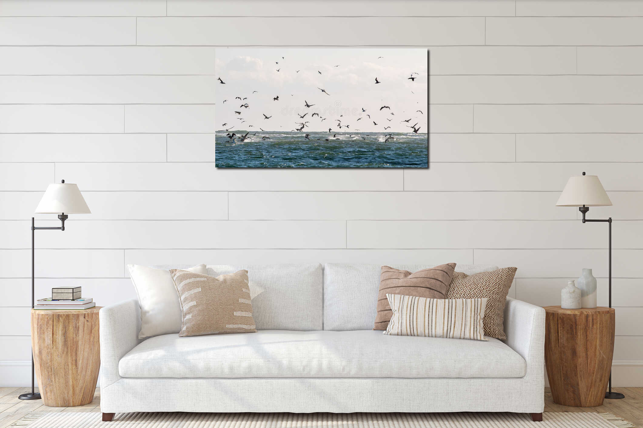 Flock of seabirds flying over a wavy ocean under a cloudy sky, capturing the essence of freedom interior mockup