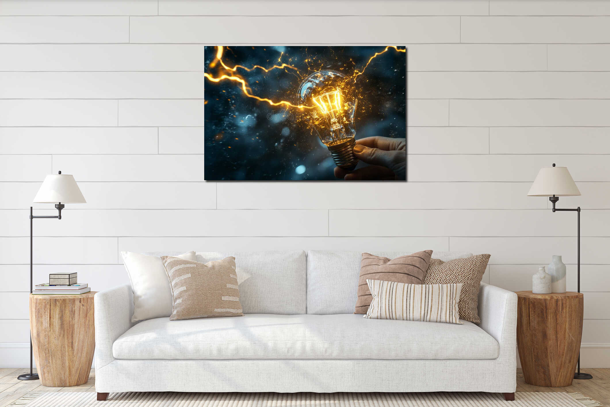 A composite collage illustration features a hand holding a light bulb, painted with energy and lightning, isolated on a interior mockup
