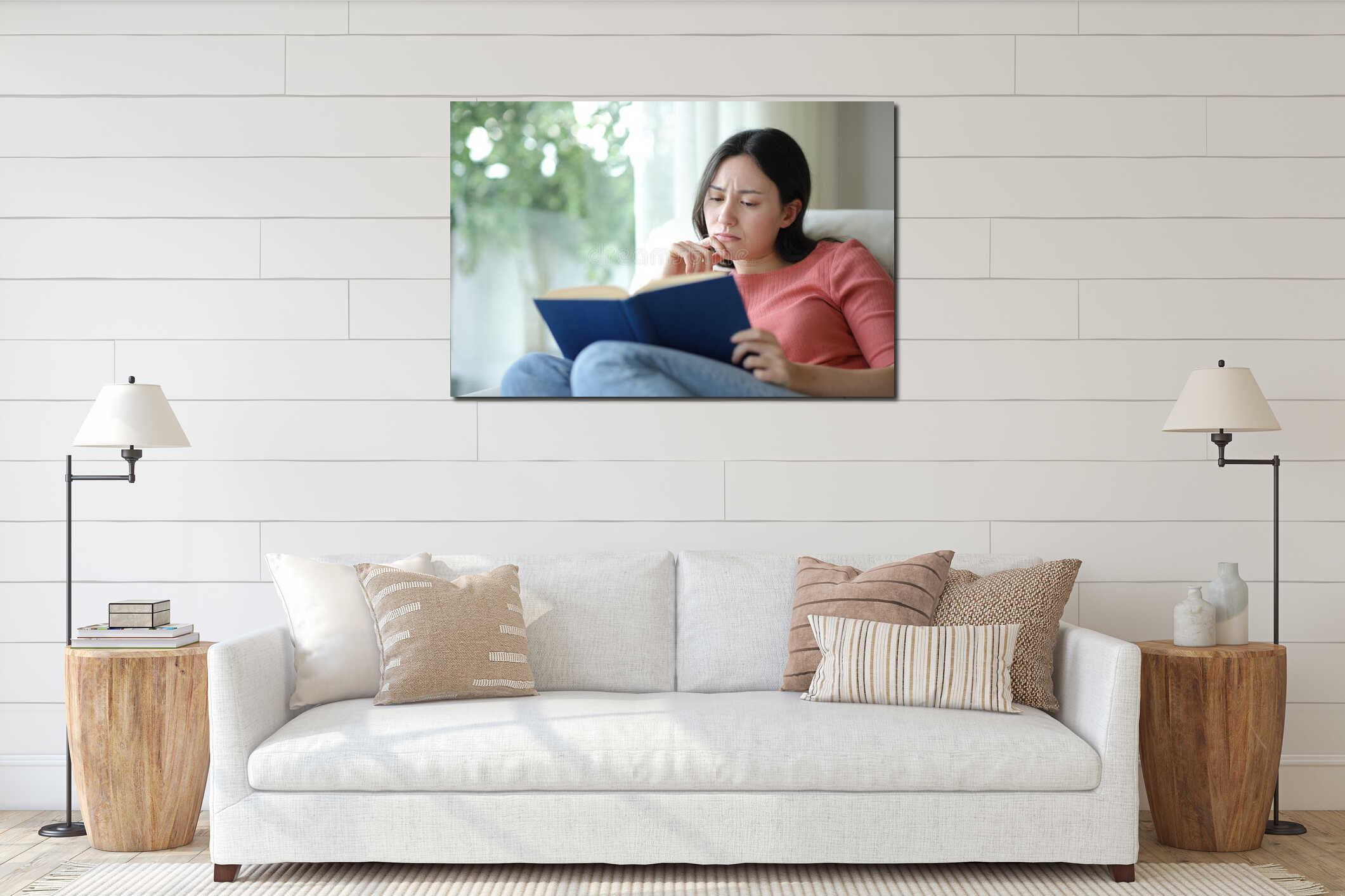 Sad asian woman reading a paper book on a couch interior mockup