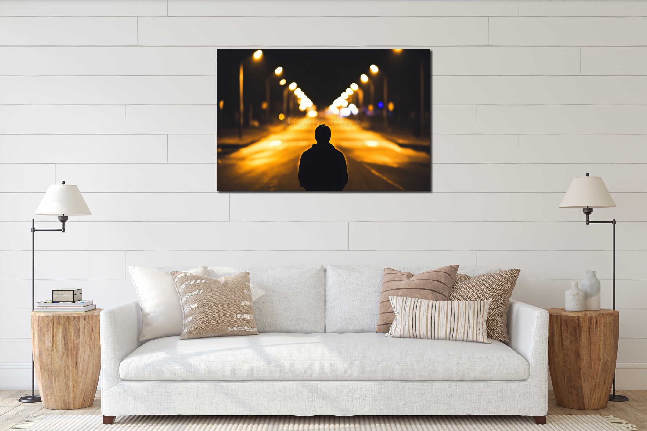 A lone person stands on a deserted street at night, illuminated by streetlights that cast long shadows, leaving a dark interior mockup