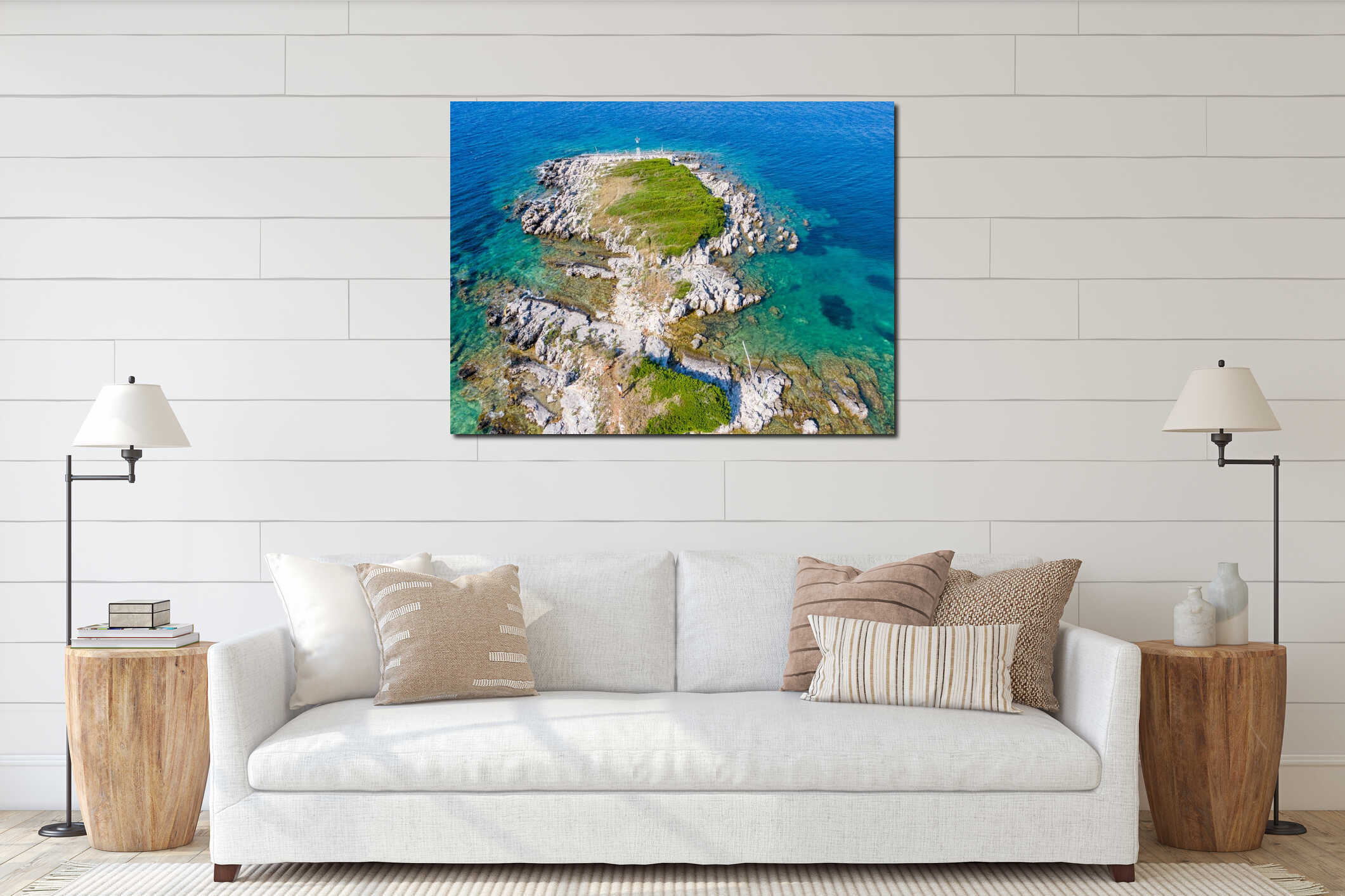 Aerial view of a small, rocky island with turquoise water and some greenery interior mockup