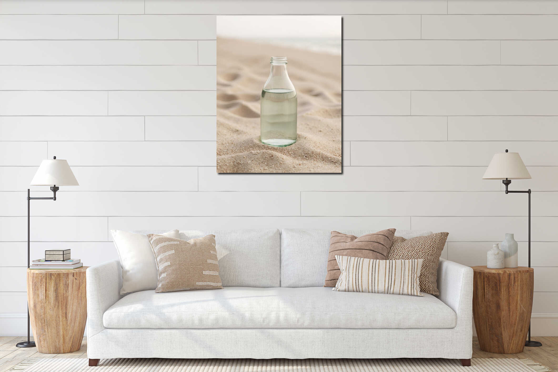 A bottle of water sitting on top of a sandy beach interior mockup