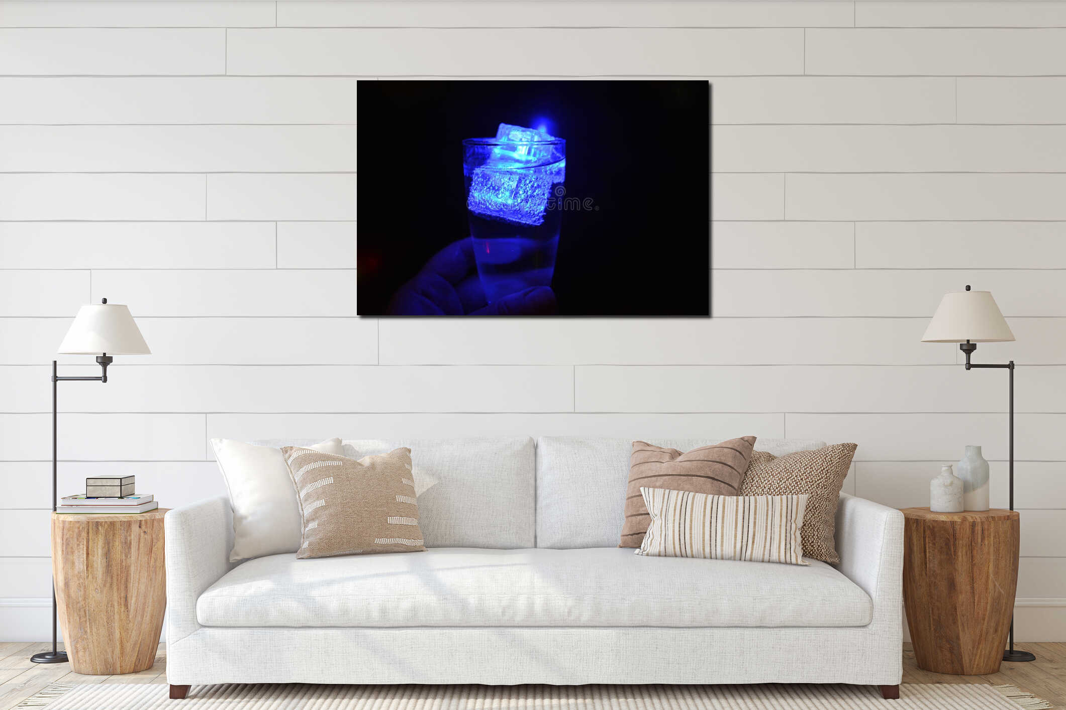 Beautiful and bright blue glowing ice cube floats in a glass champagne glass with a drink. interior mockup