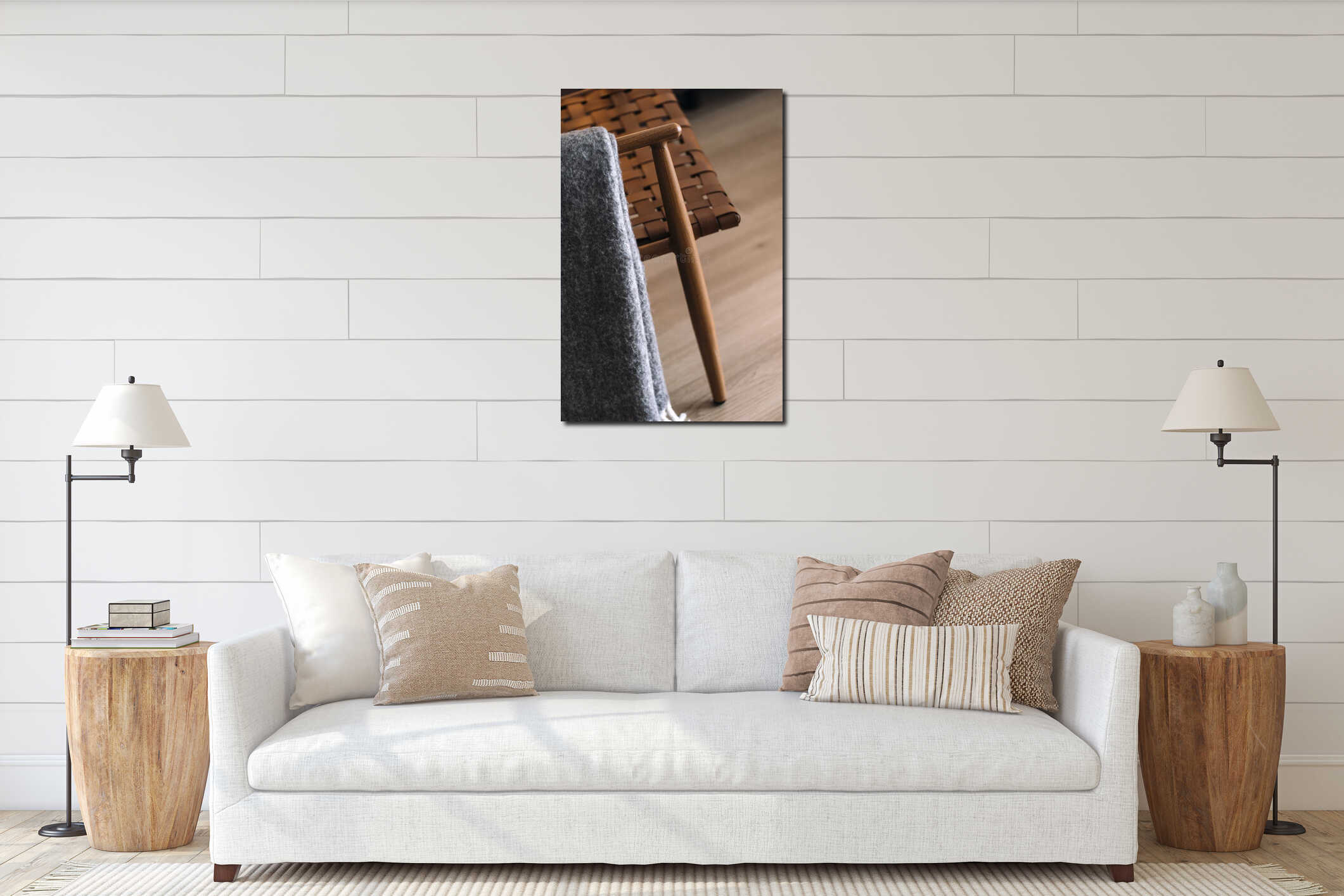 Soft grey plaid on armrest of design armchair in living room interior mockup