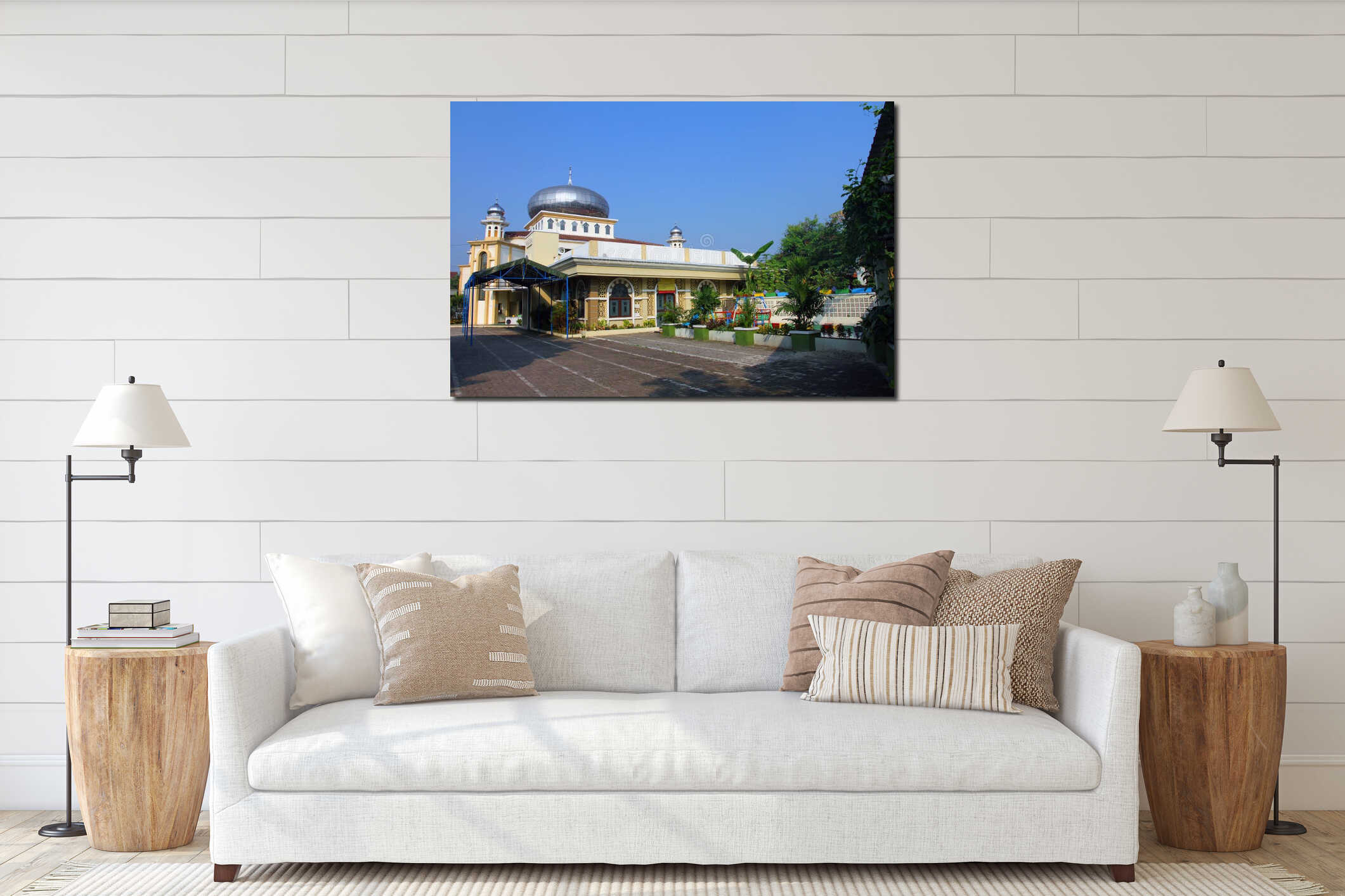 A mosque with a large silver dome, two smaller domes, arched windows,  surrounded by greenery and a clear blue sky. interior mockup