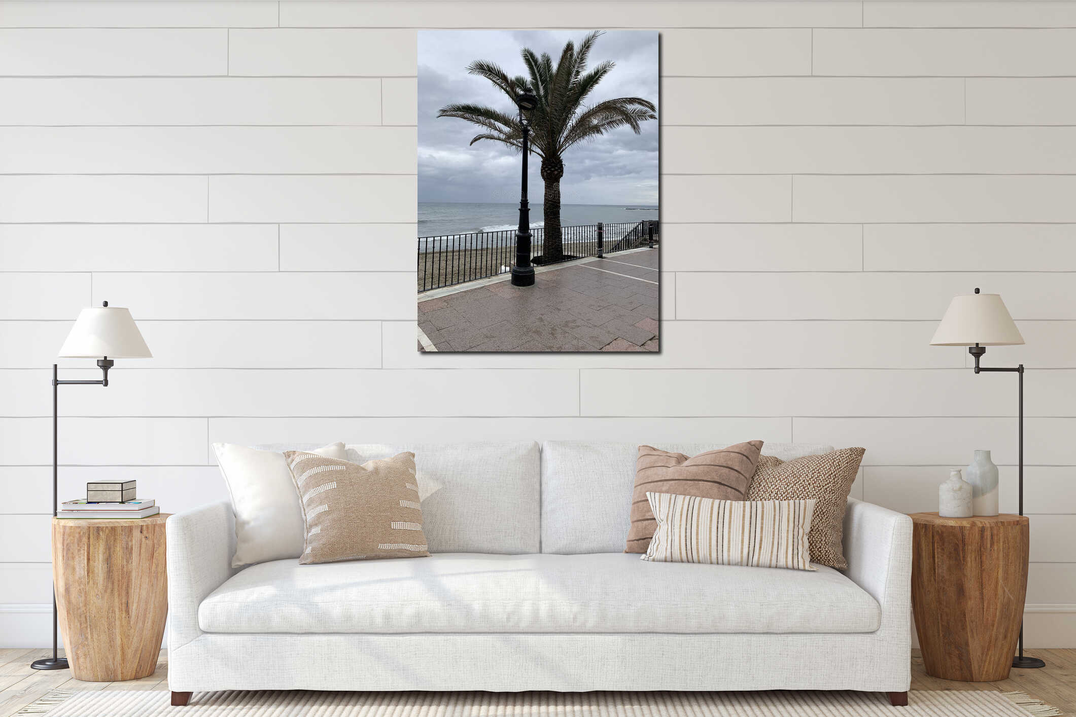 Palm tree and vintage street lamp on Marbella promenade, Spain, with cloudy sky and waves in the background. interior mockup