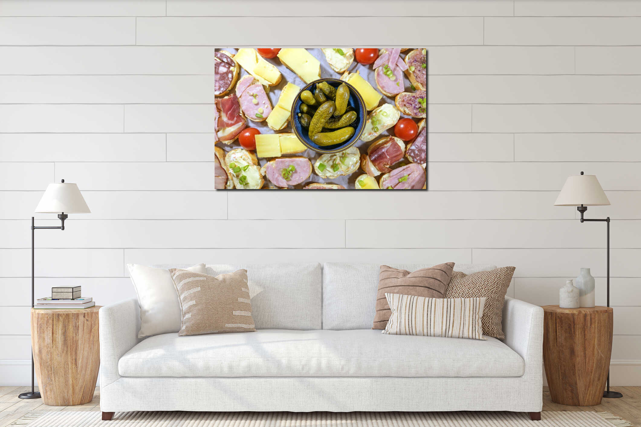 Bowl of gherkins surrounded by small sandwiches with cheese, ham and sausage, simple finger food or party snack, top view from interior mockup