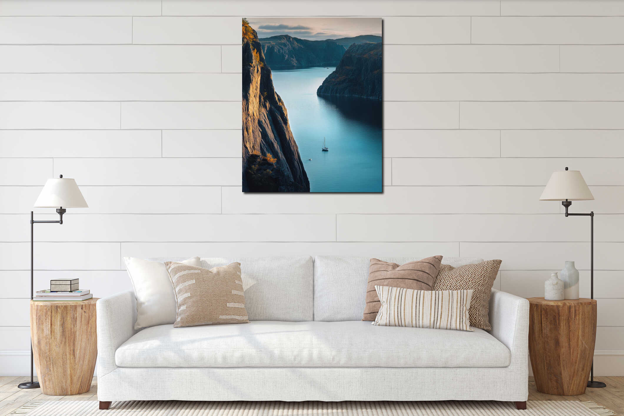 A serene landscape with cliffs surrounding a tranquil bay. A small sailboat drifts on calm waters. Nature invites you to interior mockup