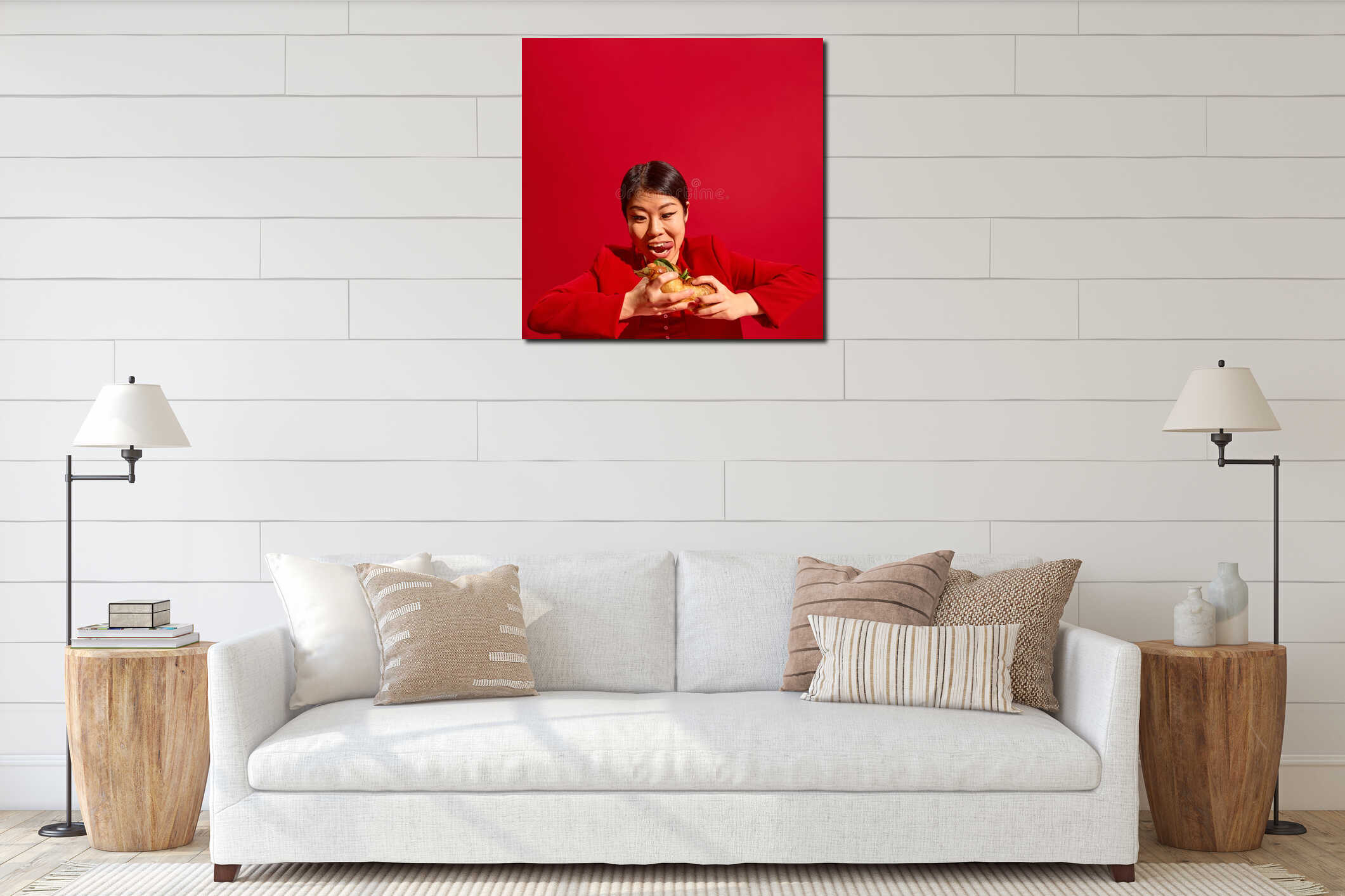 Woman in red joyfully prepares to bit delicious hot dog against bold red background. Street food aesthetics. interior mockup