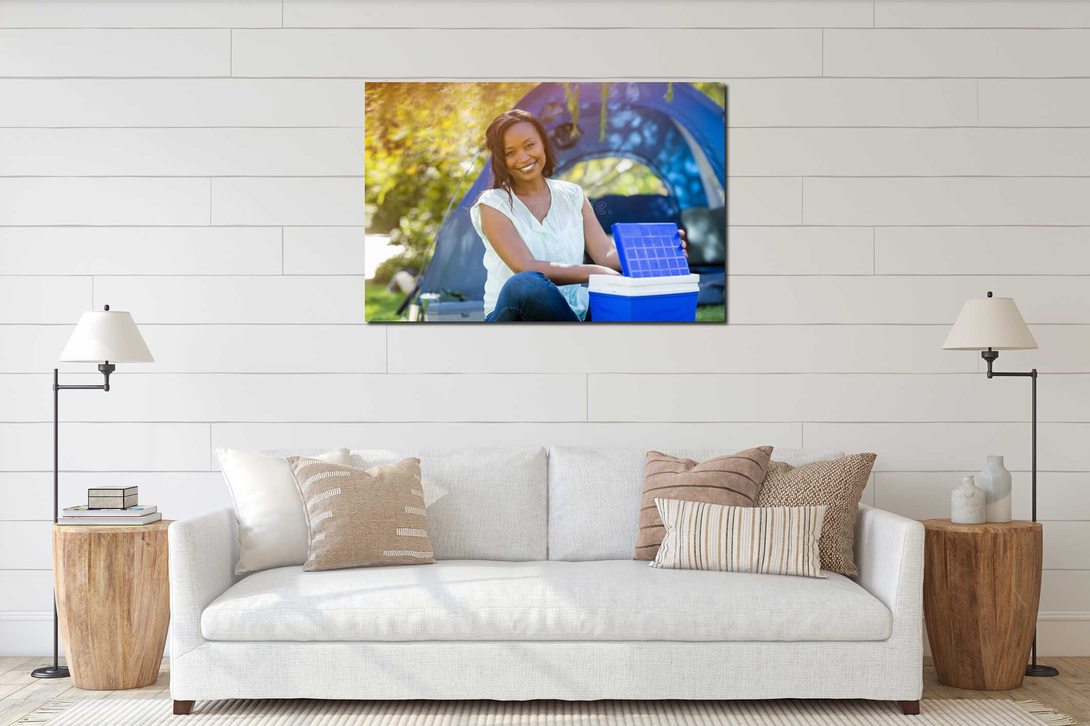 African American woman sitting on grass at campsite near blue dome tent, lifting cooler lid interior mockup