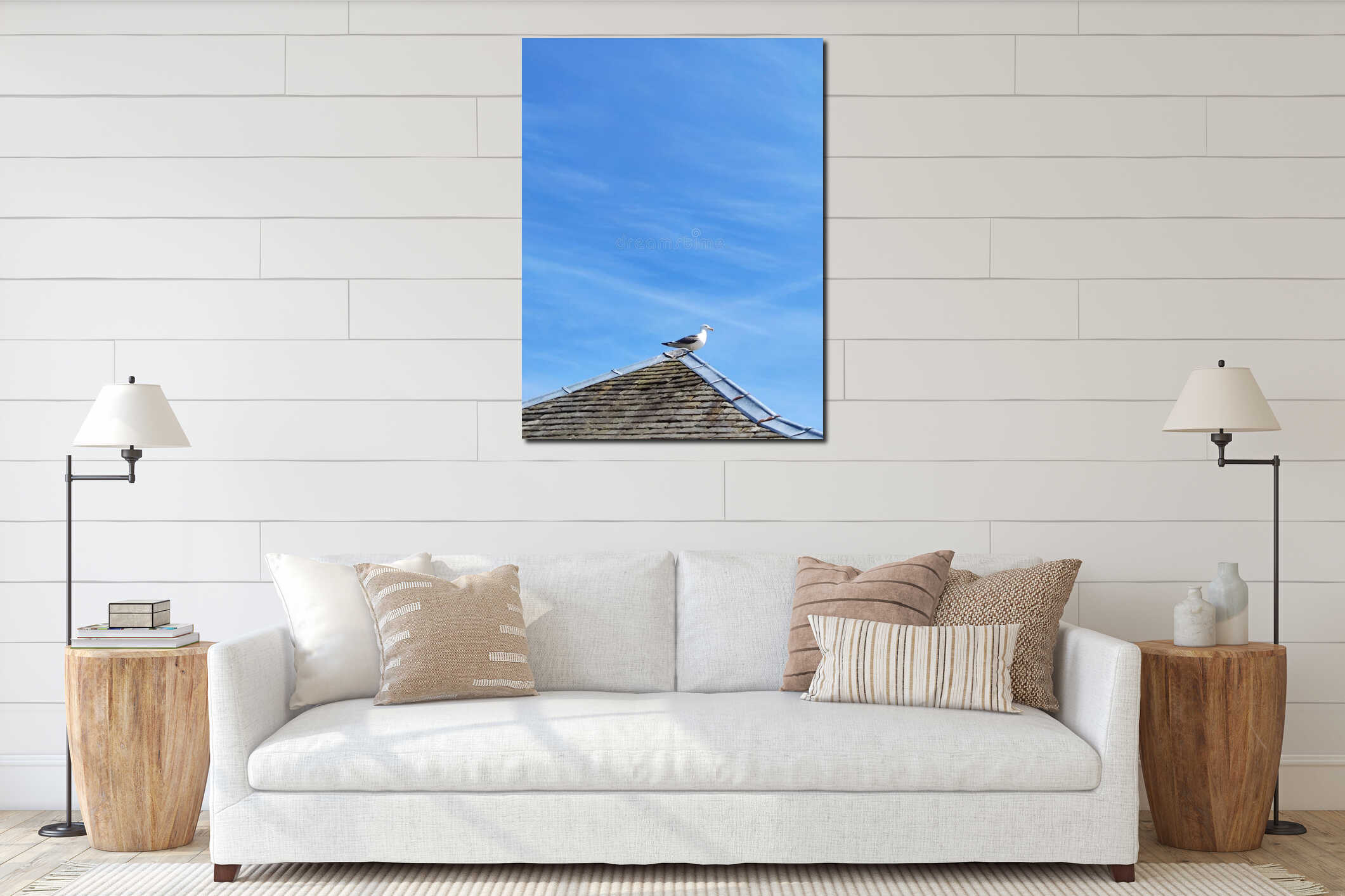 Seagull perched on tiled roof against clear blue sky with wispy clouds interior mockup