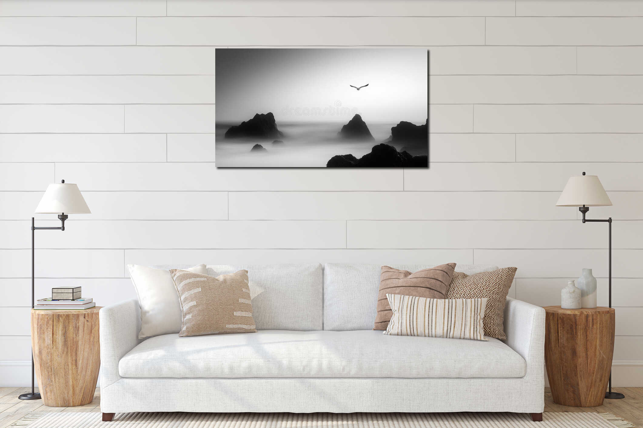 Rocky coastline with a bird soaring above in misty atmosphere at dawn interior mockup