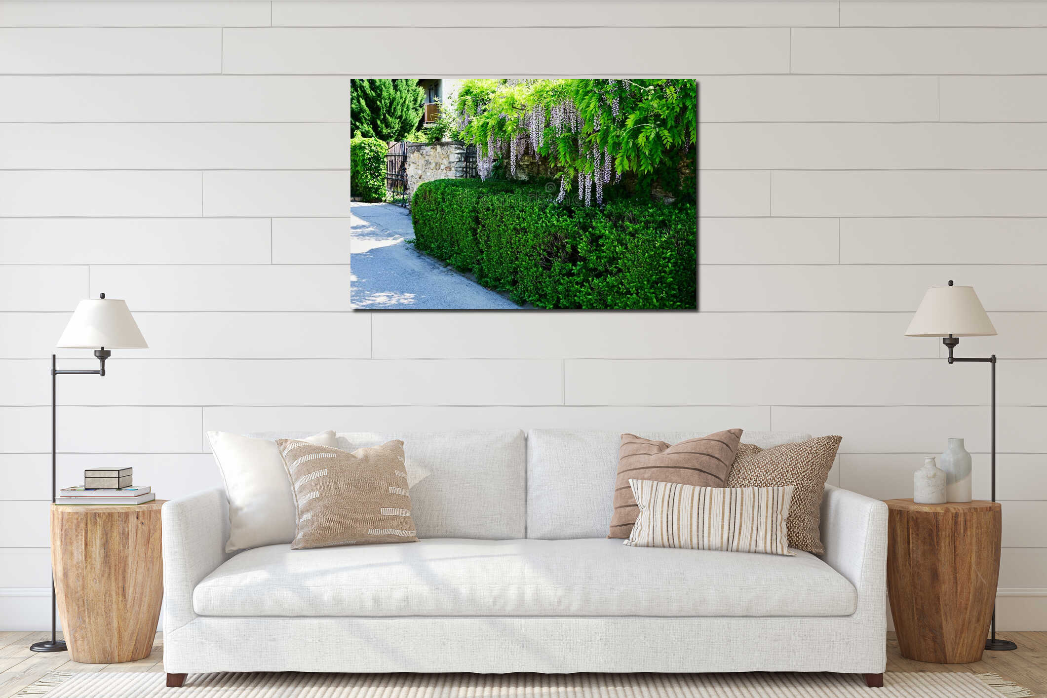 lush green hedge and stone fence. hanging blooming purple acacia flowers and leaves. forged black iron picket gate interior mockup