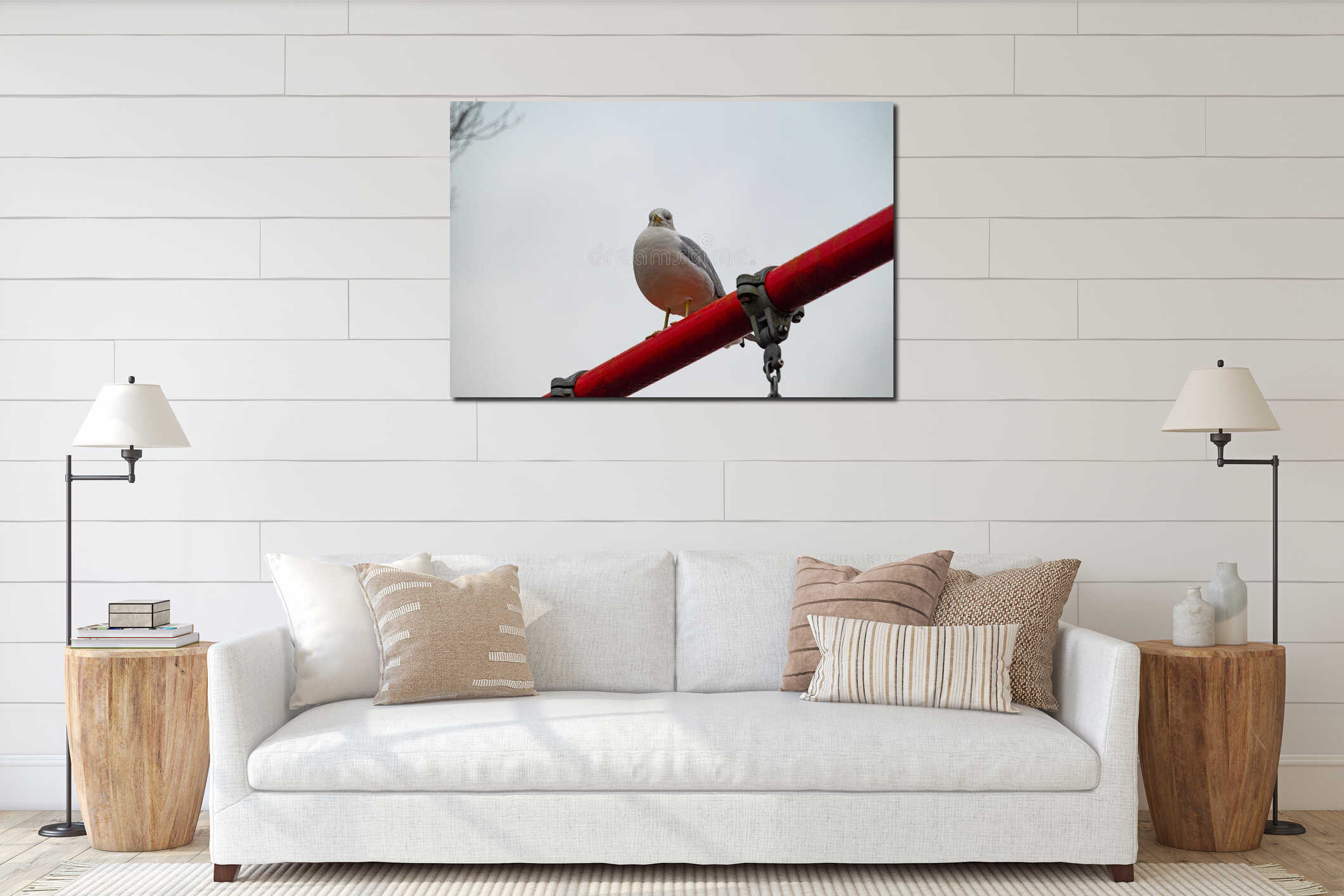 Seagull sitting on a red rope on a background of gray sky. interior mockup