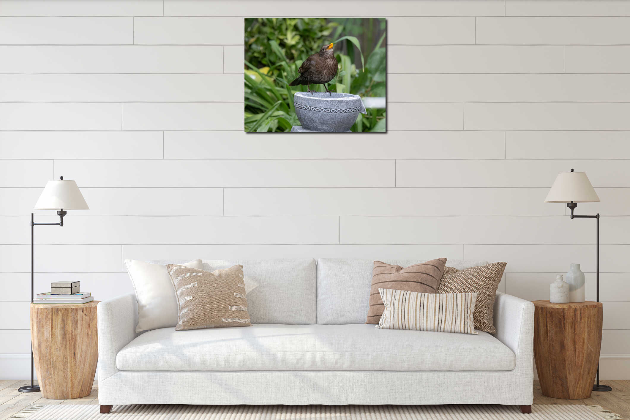 Brown bird perched on stone bowl in garden. interior mockup