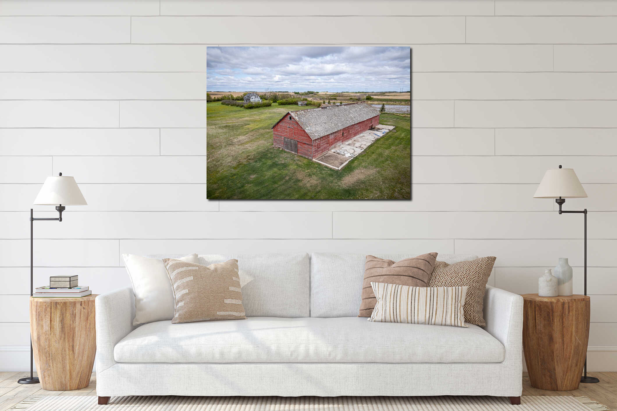 Red barn with a large roof sits in a field interior mockup