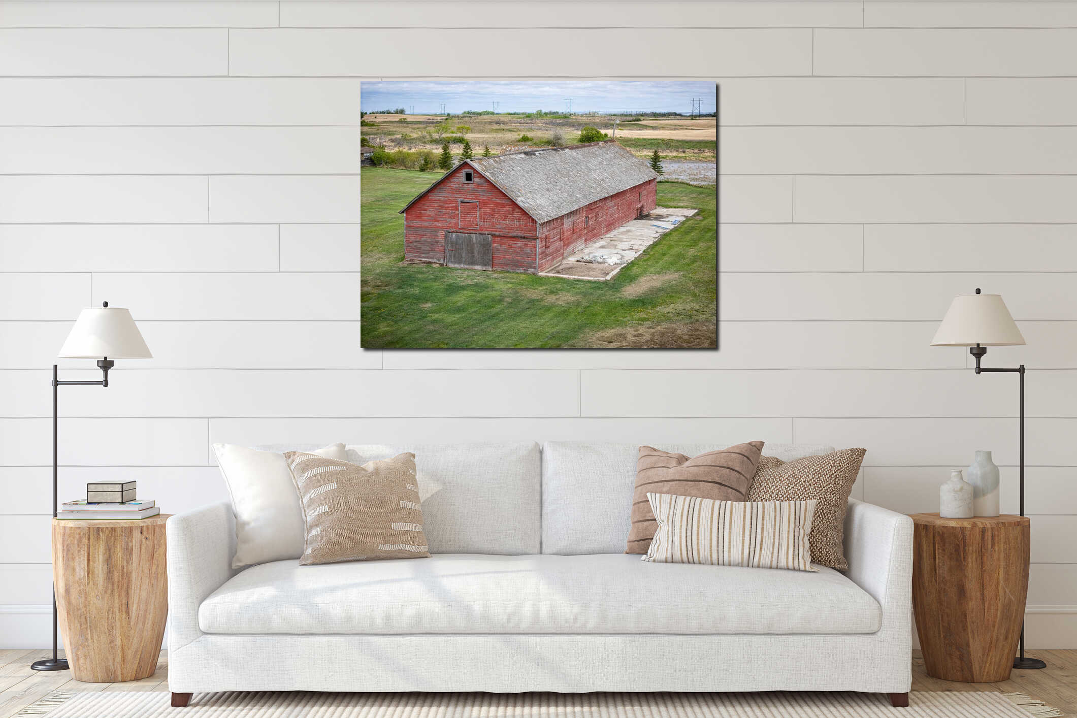 Red barn with a large open door sits in a field interior mockup