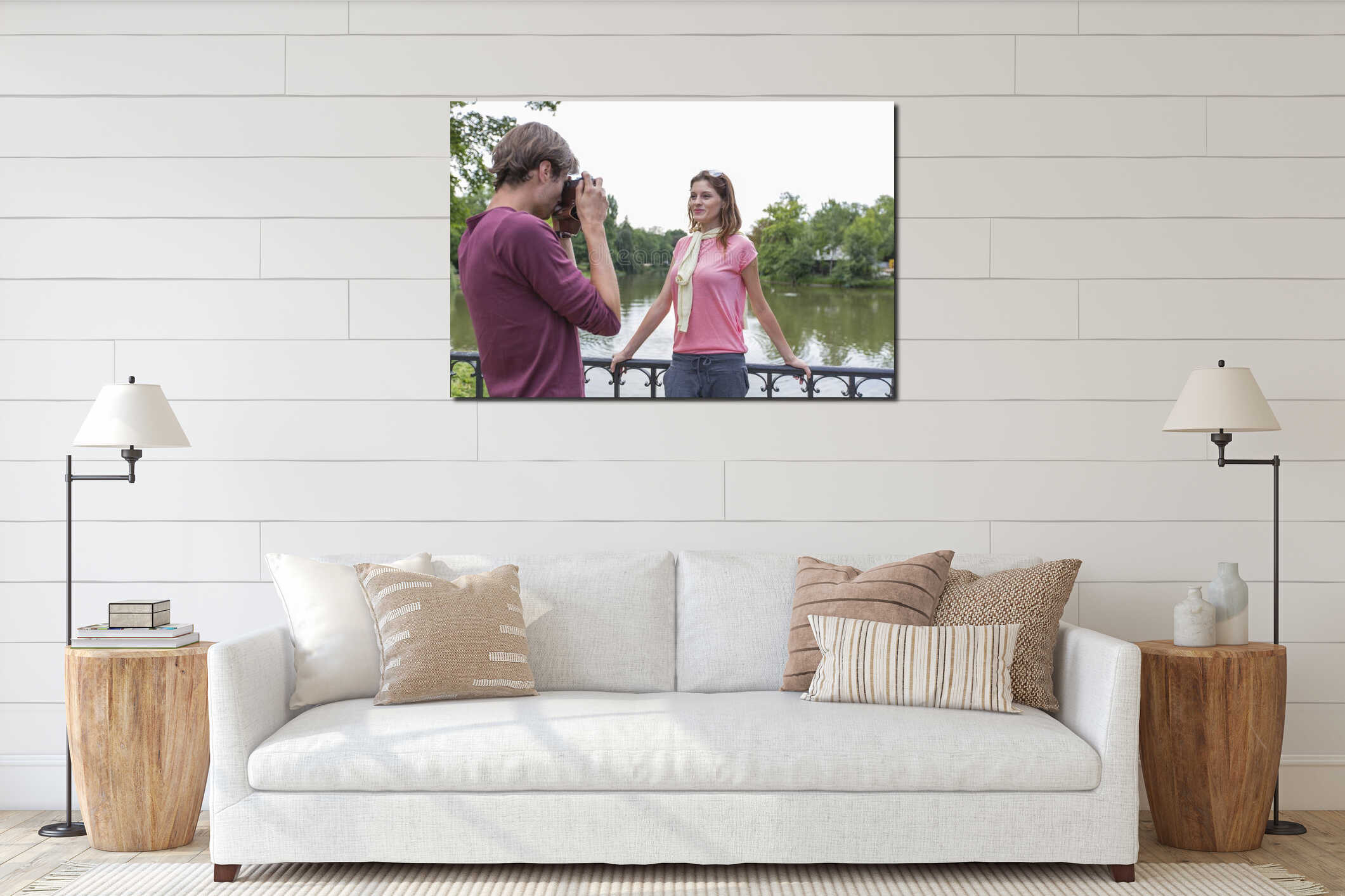 Young man photographing woman at lakeside interior mockup