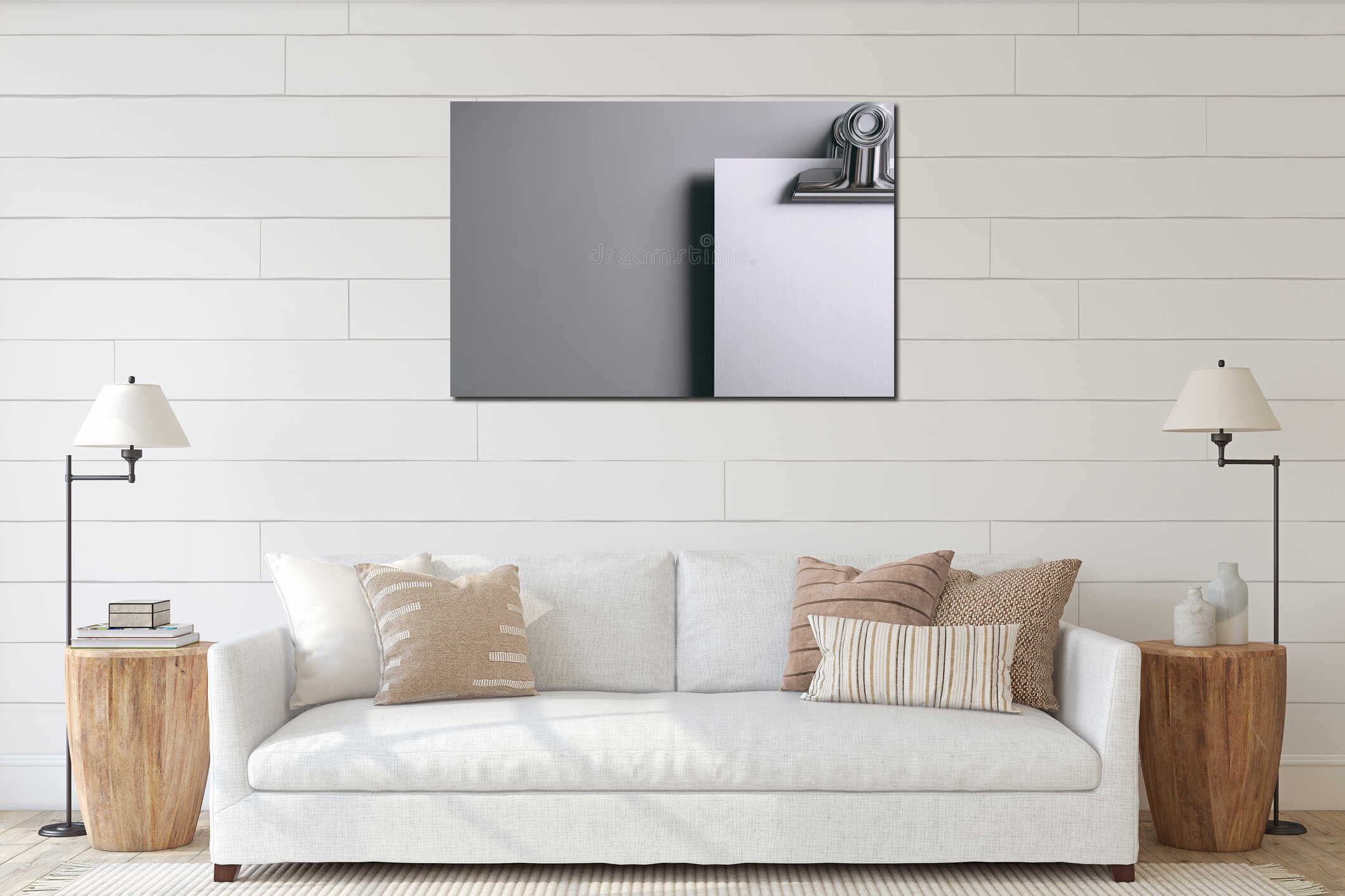 Blank sheet of paper secured by a metal clip against a plain gray wall in a minimalist setting interior mockup