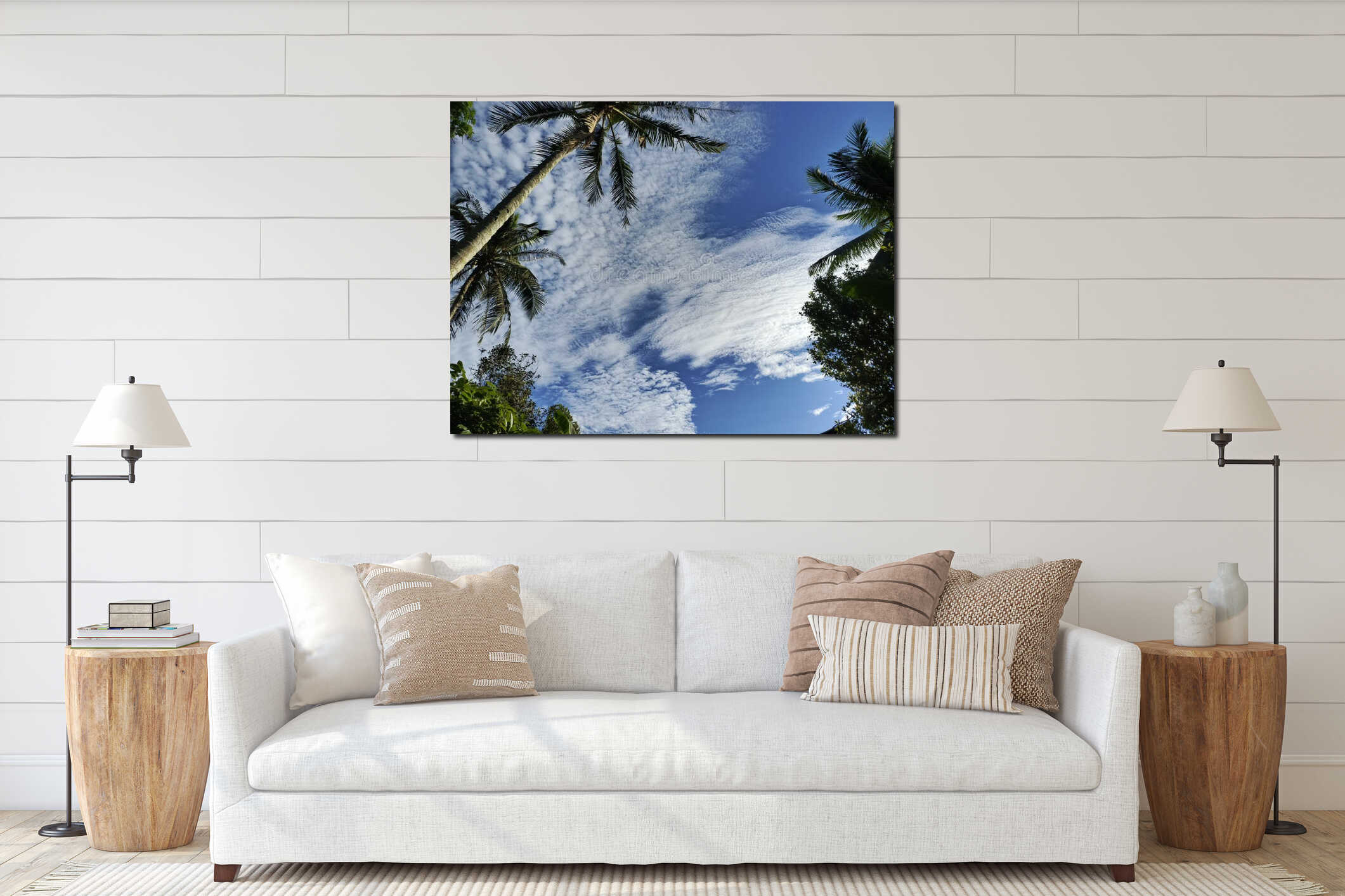 Blue sky filled with scattered white clouds, seen from a low angle, with lush green palm trees and other foliage framing the view. interior mockup