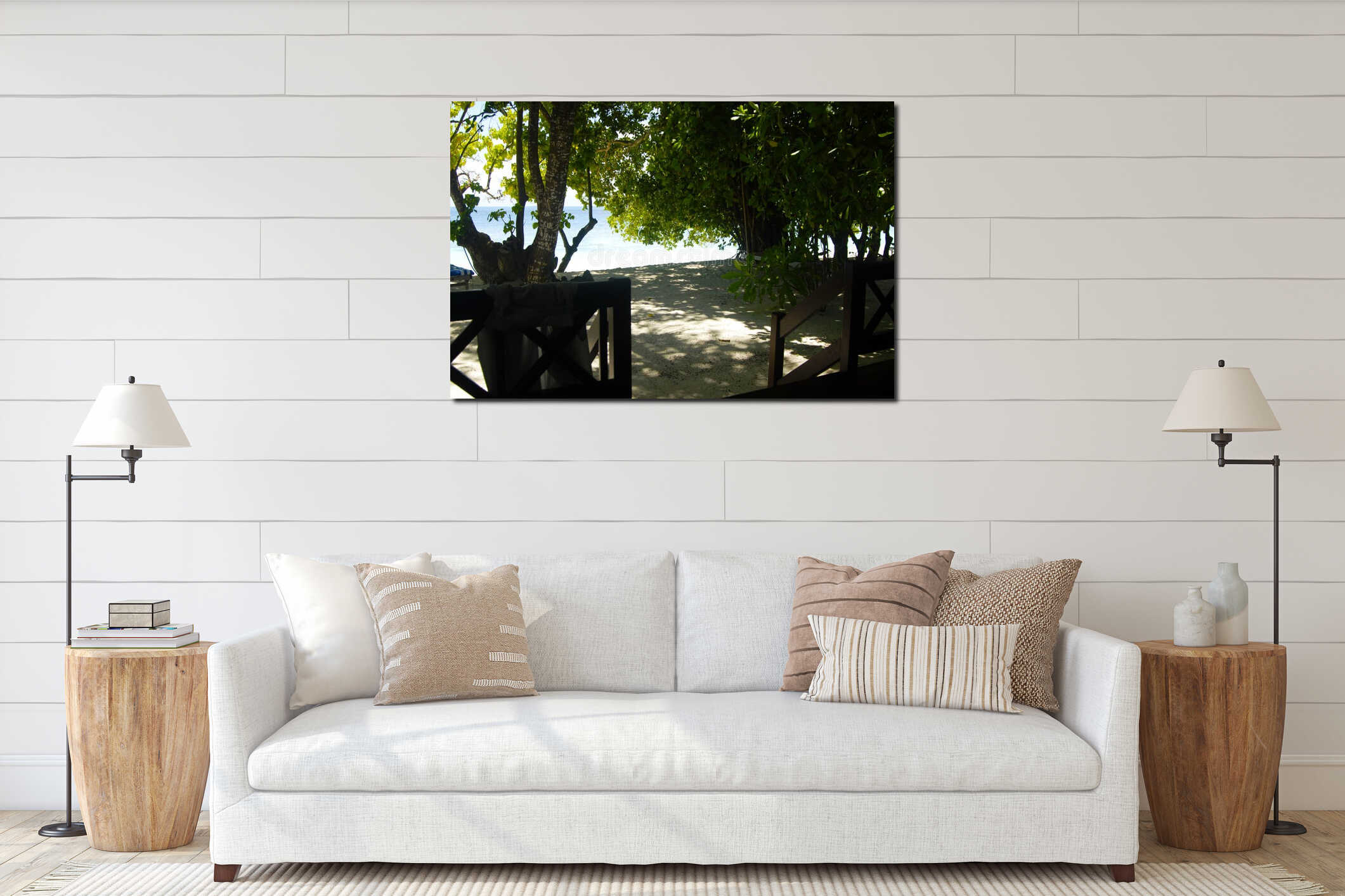 Serene beach view through lush greenery with sandy shore and bright blue ocean interior mockup