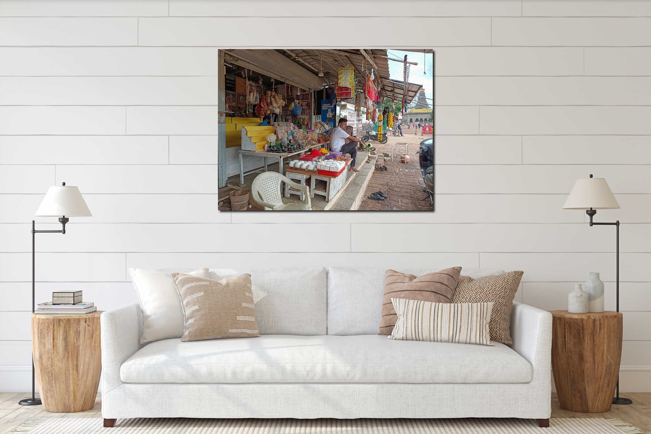 A man sits outside a vibrant shop selling religious items, photos, souvenirs near temple entrance. interior mockup