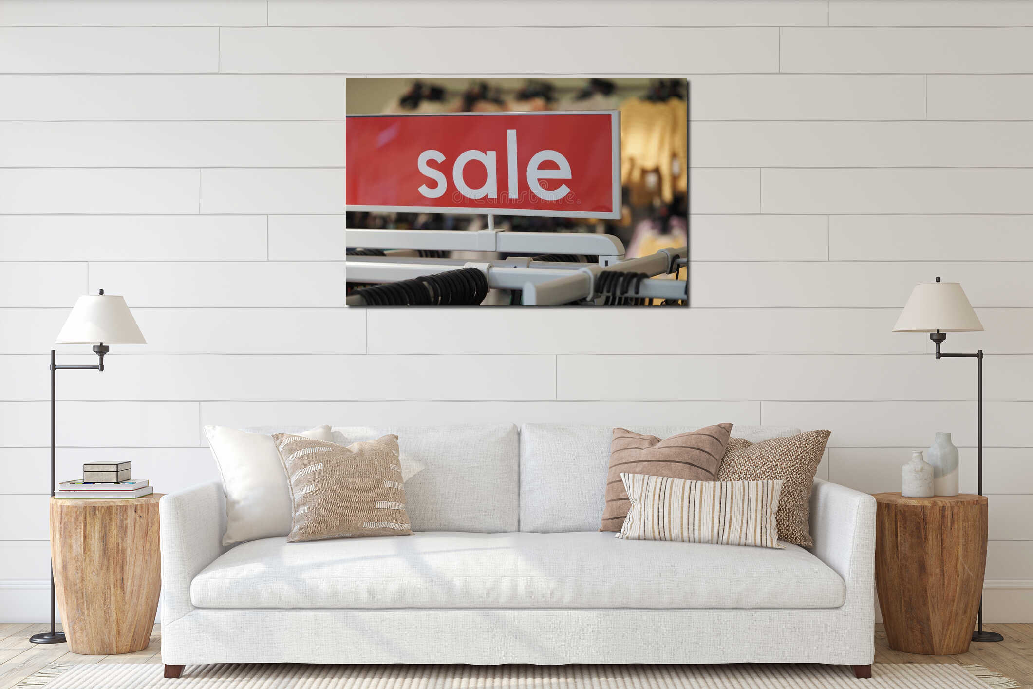 A vibrant sale sign hangs above clothing racks in a retail store interior mockup