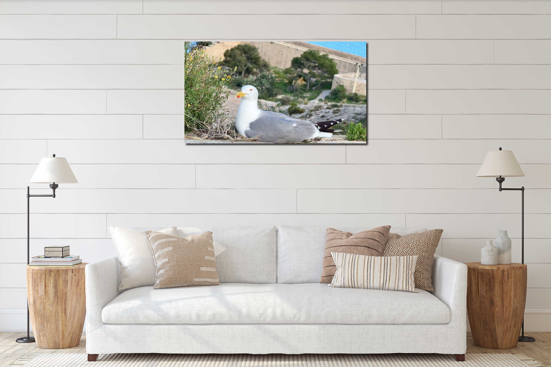 A seagull nesting on a rugged cliff, surrounded by a stunning coastal landscape interior mockup
