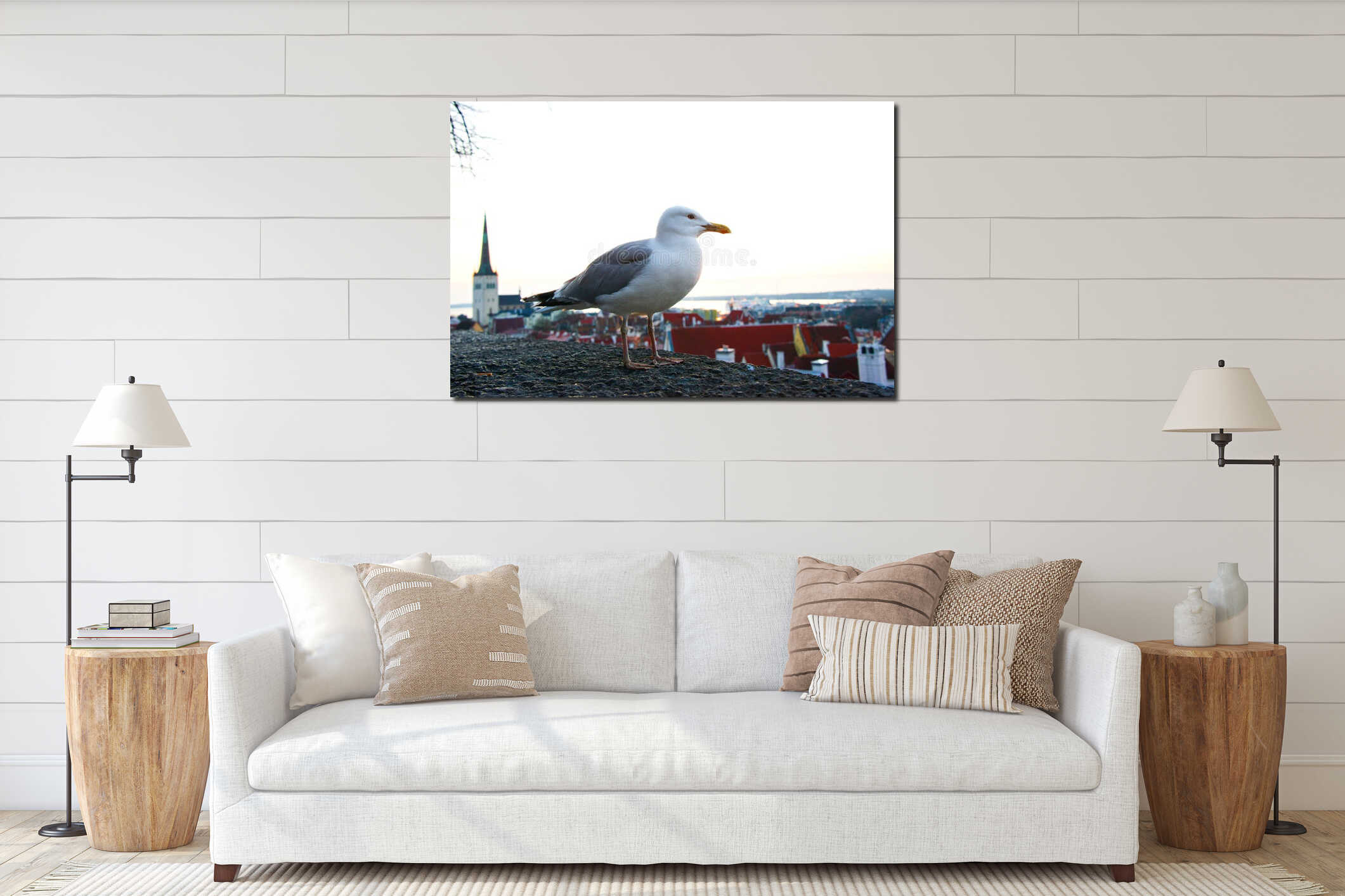 A seagull perched on a rooftop overlooking the city of Tallinn, Estonia, at sunset interior mockup