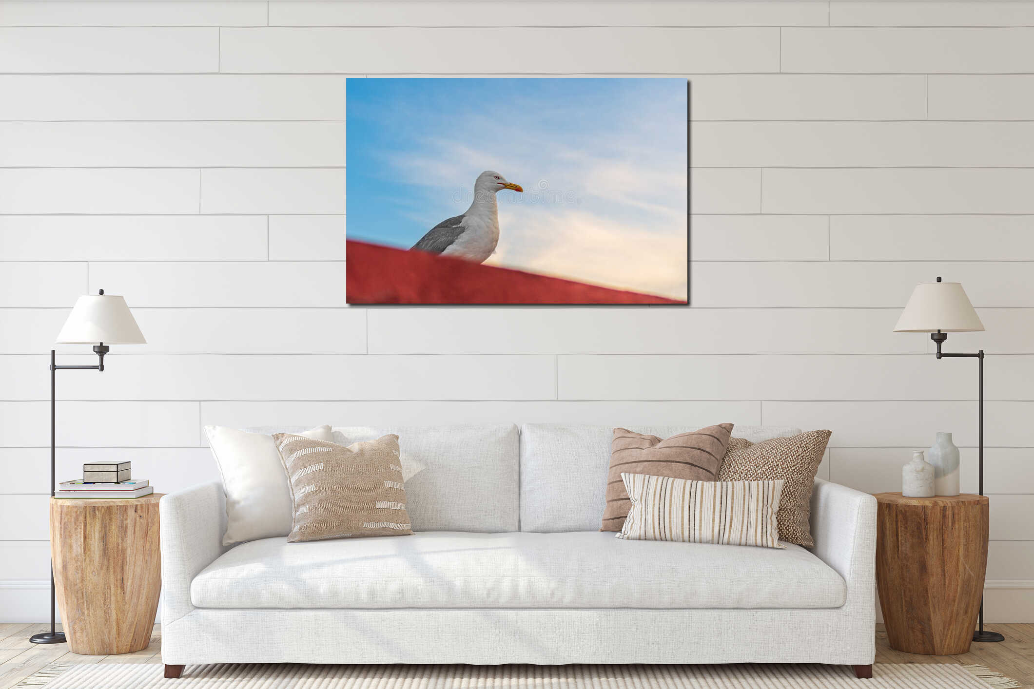 Adult ivory gull, seagull with black wings sits on edge of roof and looks towards sunset, with copy space for text against blue interior mockup