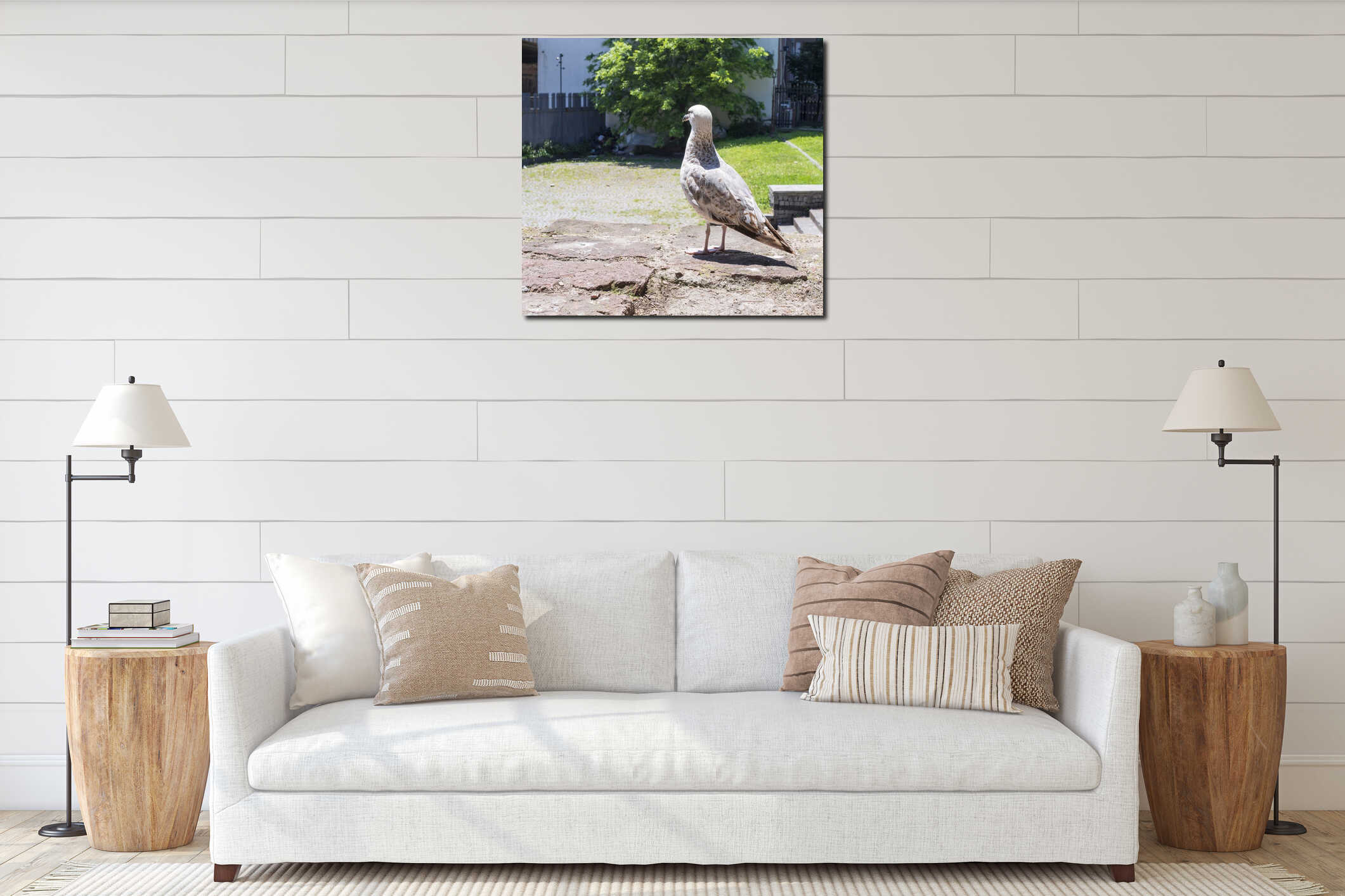 Urban seagull on a stone wall in sunny park with motorcycles and trees in background interior mockup