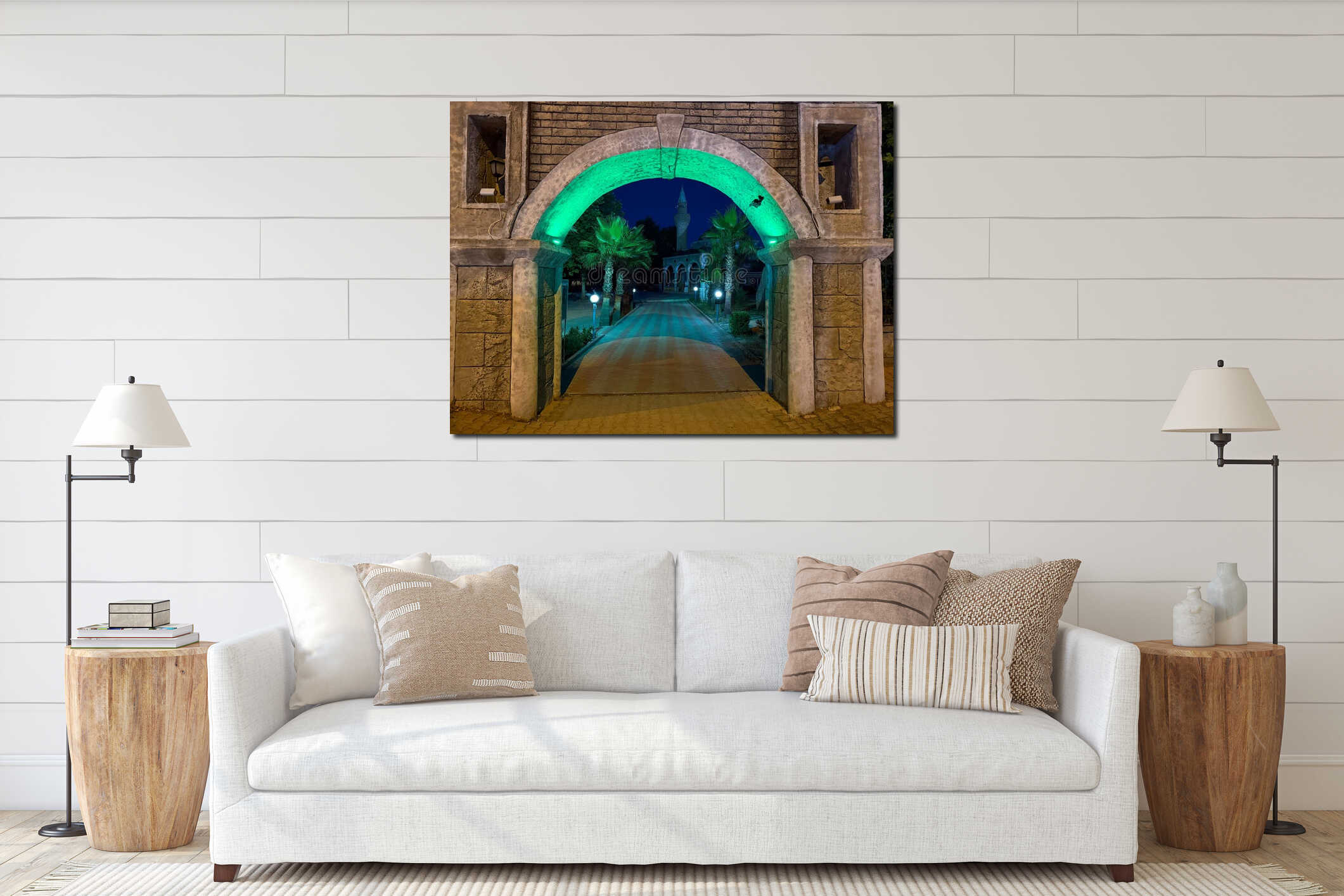 Stone arch with green illumination frames view of mosque and palm trees. Architecture, culture, and spirituality connecting interior mockup