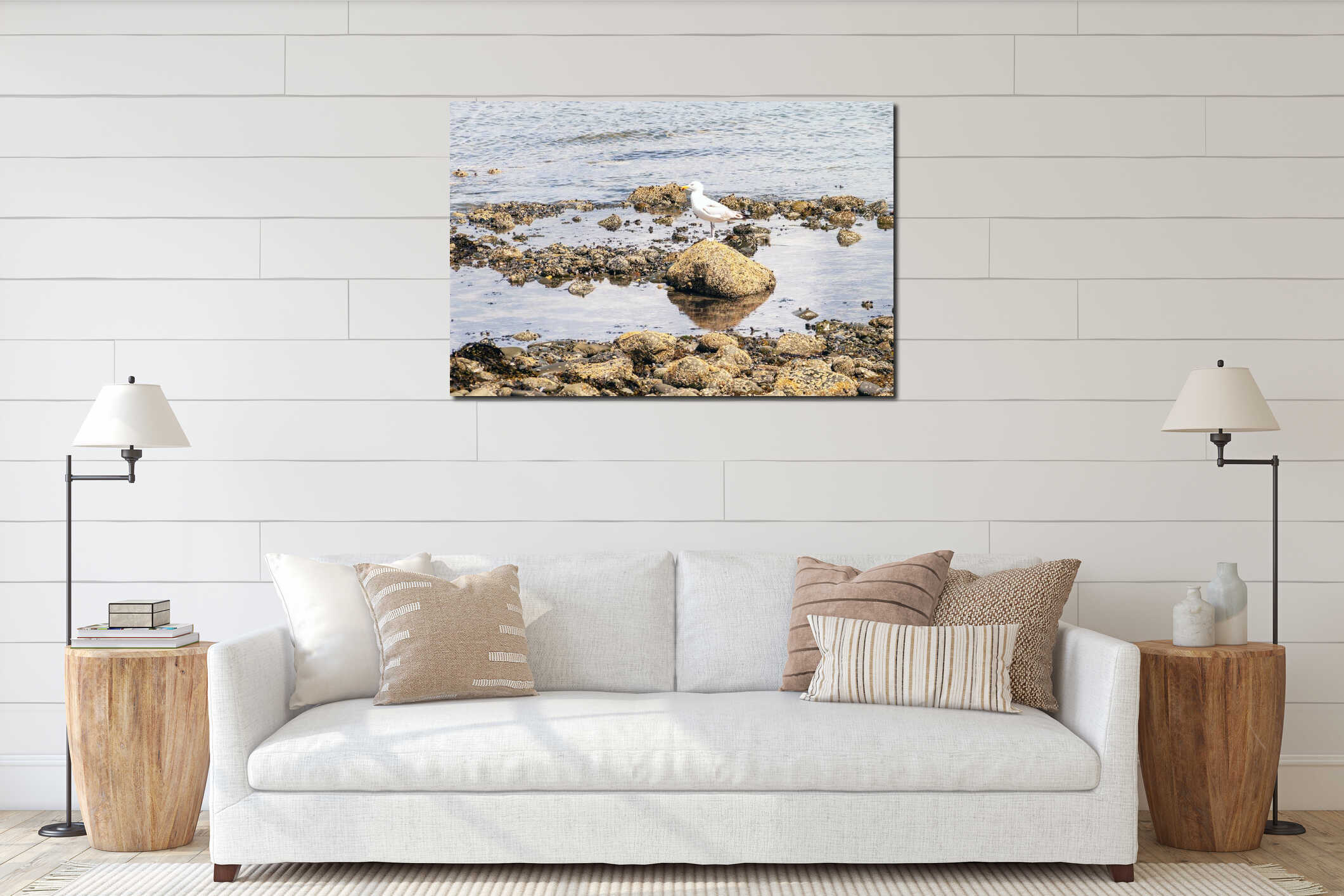 A seagull is standing on a rock in the ocean interior mockup