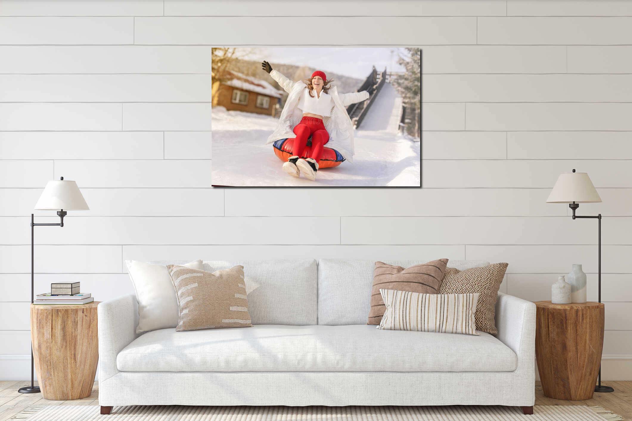 A young woman with a bright red beanie and matching leggings is joyfully tubing down a snowy slope. Dressed in a cozy white coat interior mockup
