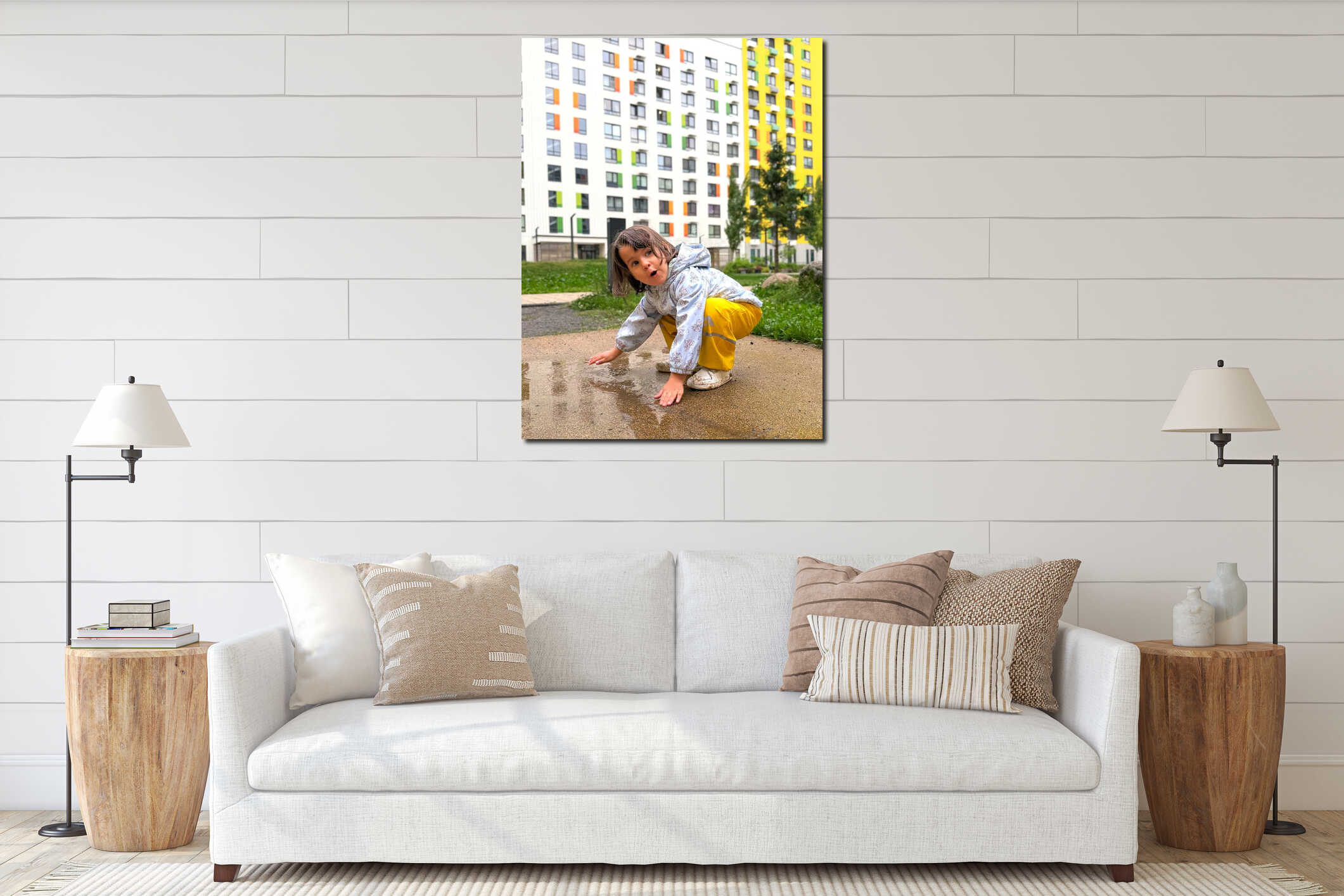 Curious little girl touching a rain puddle on the sidewalk in a modern residential courtyard, concept of childhood interior mockup