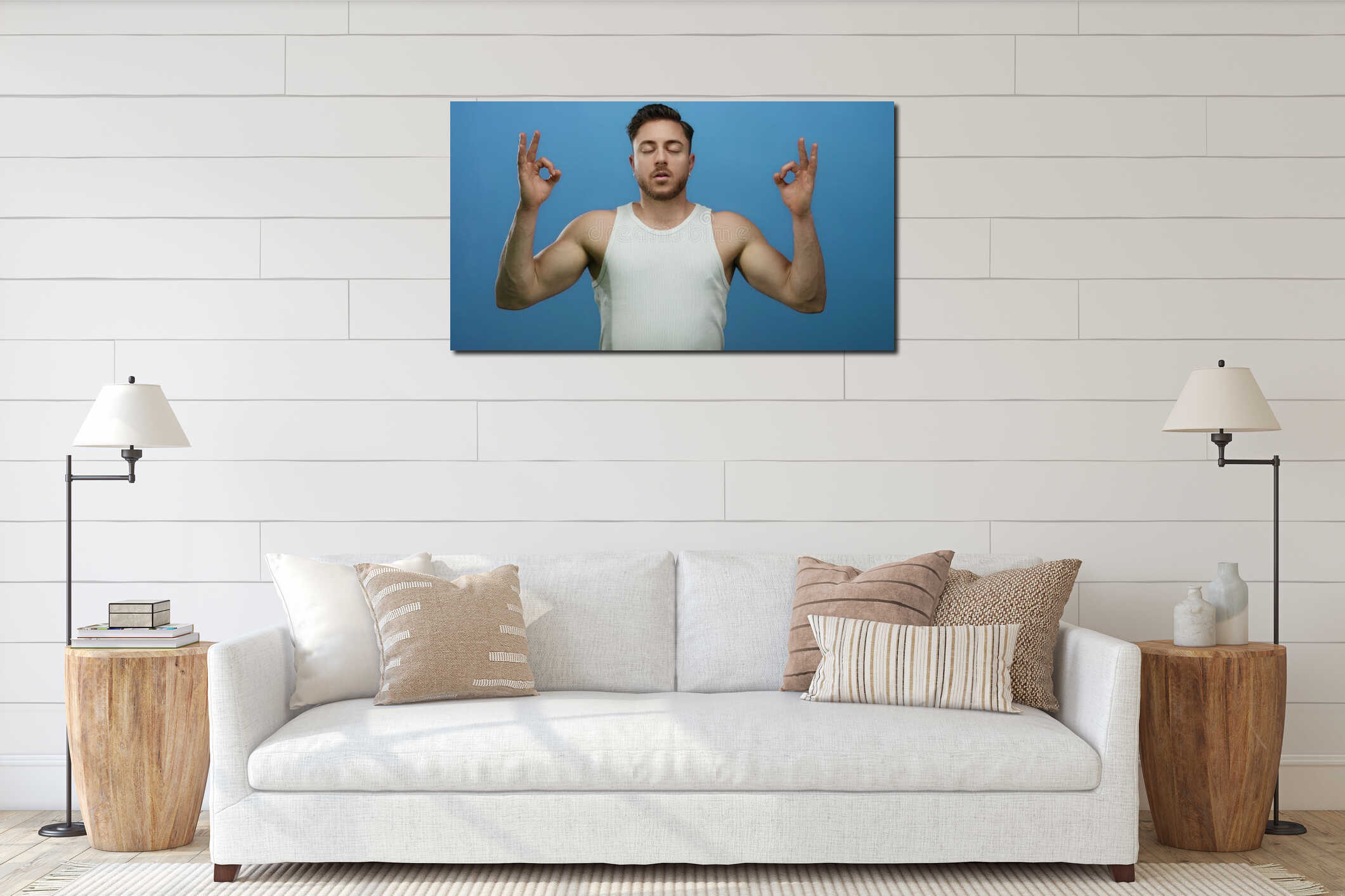 Young man with beard meditating in white tank top against blue background with eyes closed in serene pose interior mockup