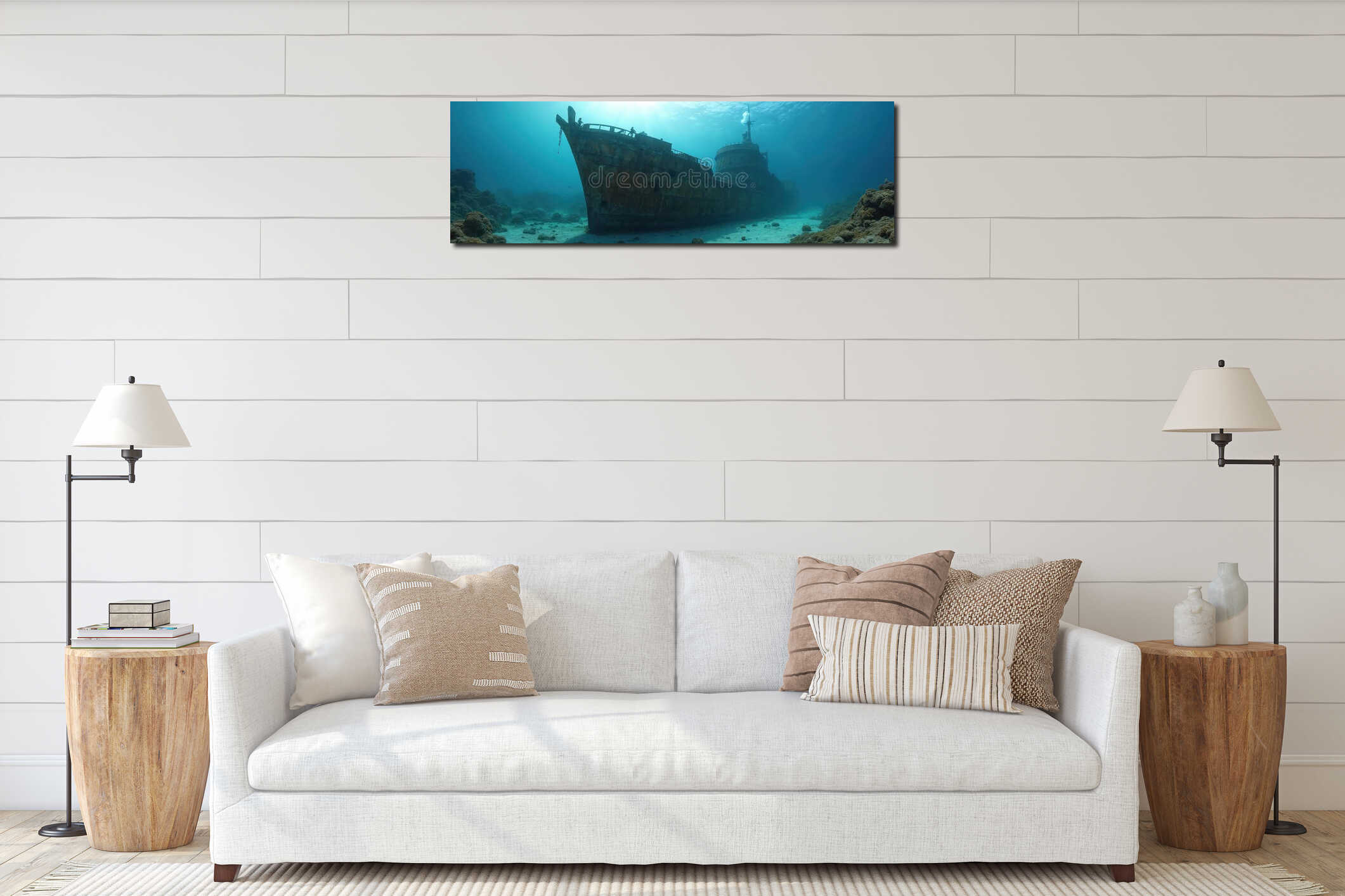 Large rusty shipwreck rests on sandy seabed. Two divers explore old vessel under clear blue ocean water with sunlight beams. interior mockup