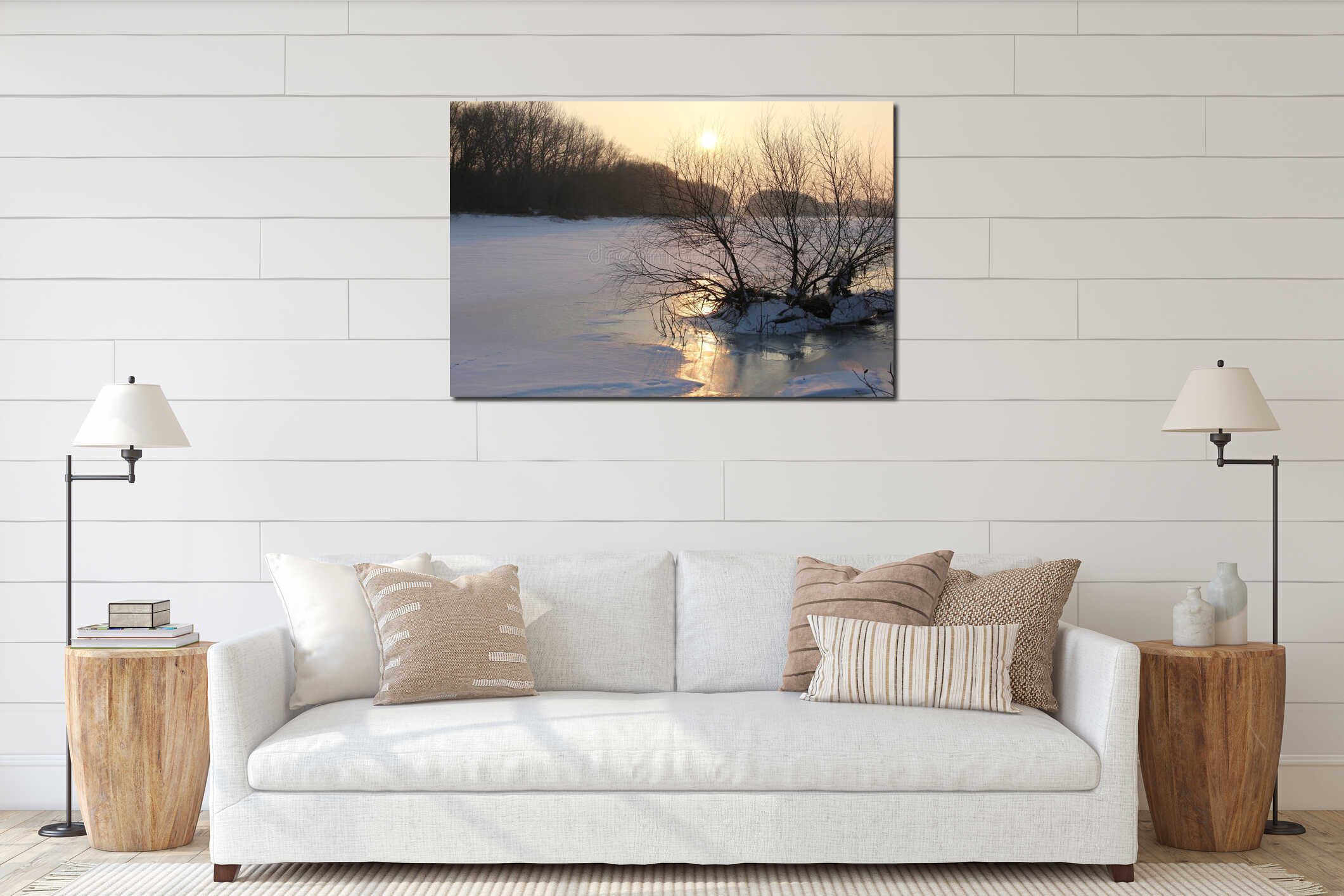 A bare tree stands gracefully at winter's edge where ice meets open water interior mockup