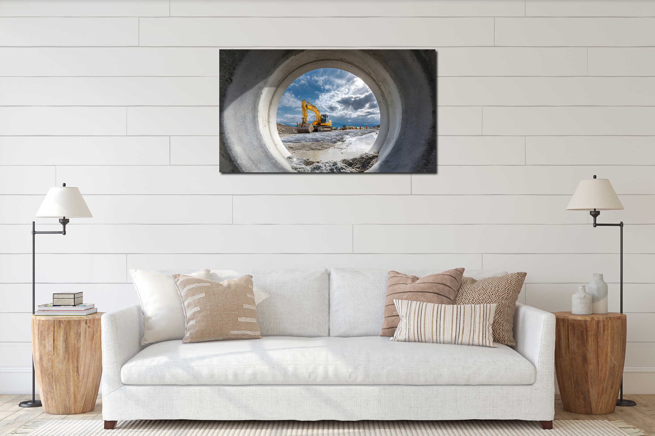 View through large concrete drainage pipe showing yellow excavator with bucket working at construction site, blue sky interior mockup