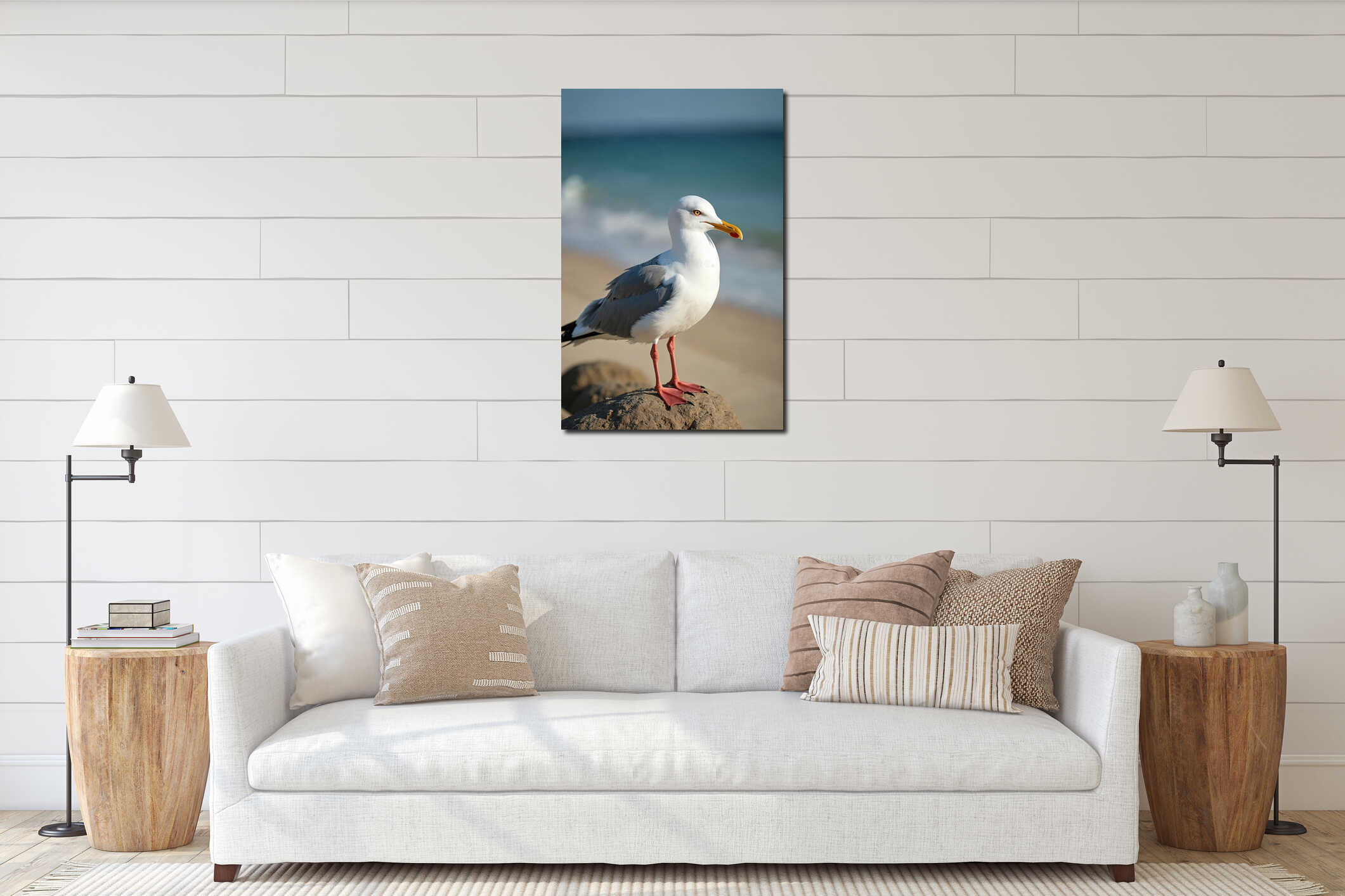 Seagull stands on rock near ocean shore. Coastal bird on sand background. White bird with yellow beak and red legs at sunny interior mockup