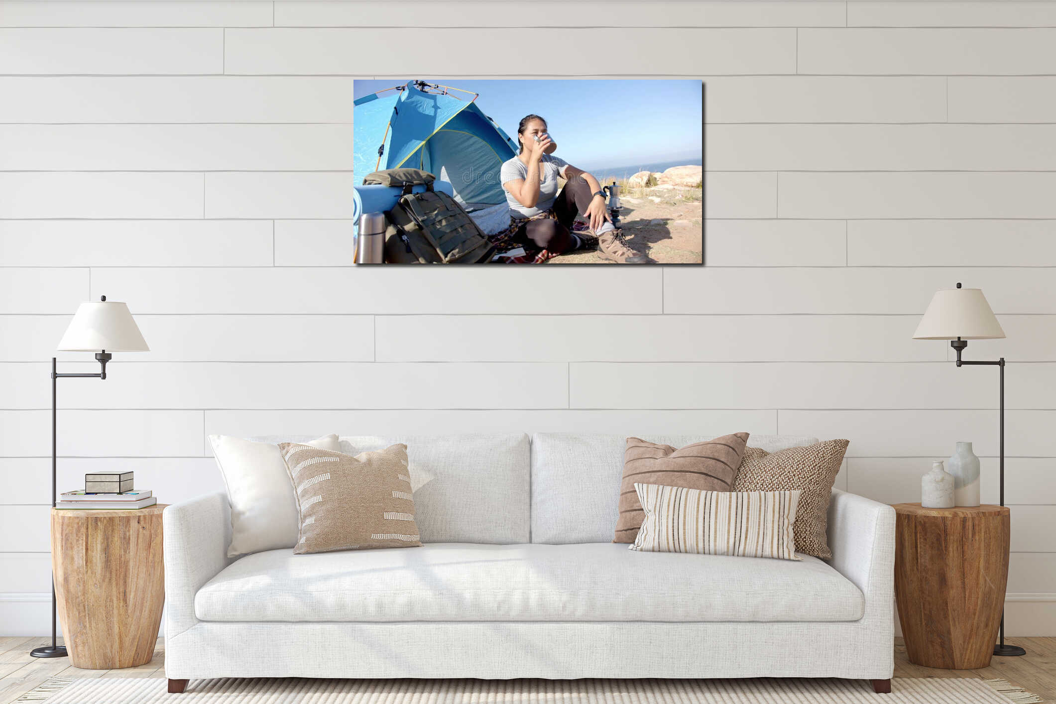 Sitting adult woman sipping from metal cup at coastal bluff campsite, with blue tent and backpack interior mockup
