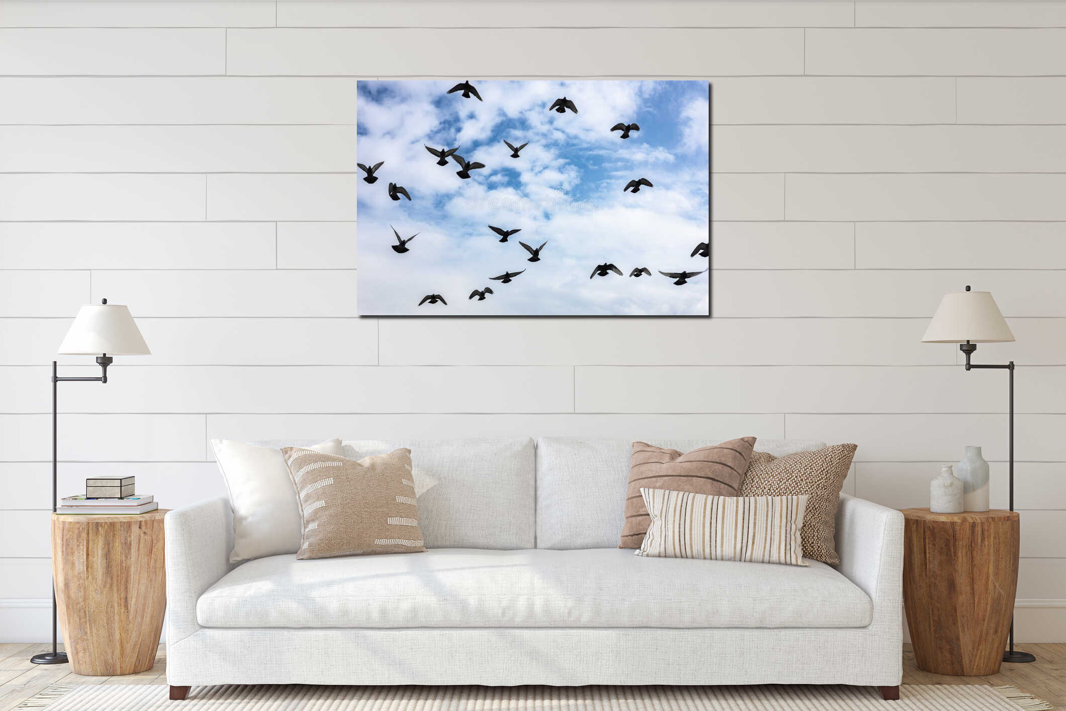 Silhouette of a flock of birds flying against a blue cloudy sky interior mockup