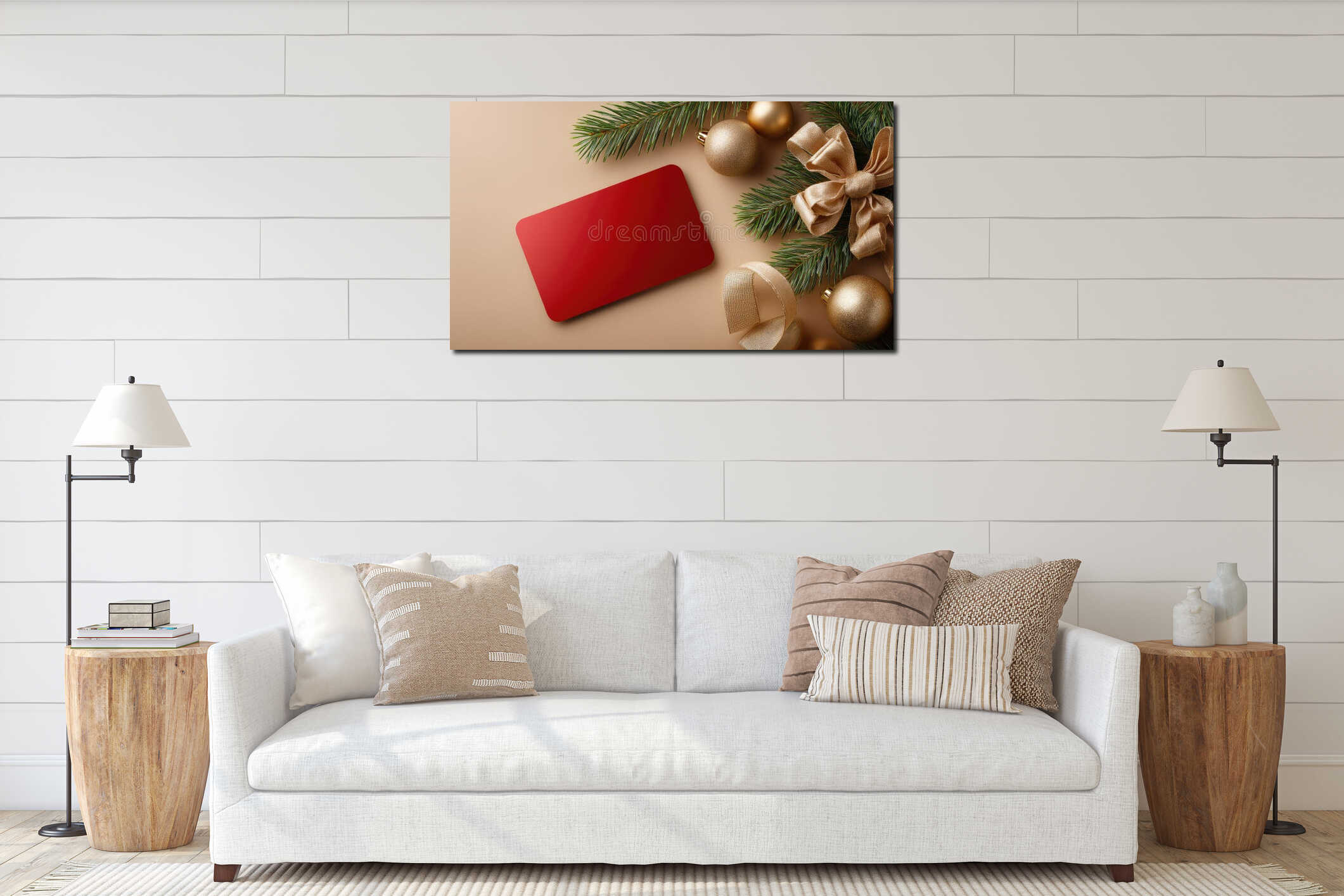 Bright red card rests on a smooth surface with green pine branches and shiny ornaments, creating a holiday atmosphere of interior mockup