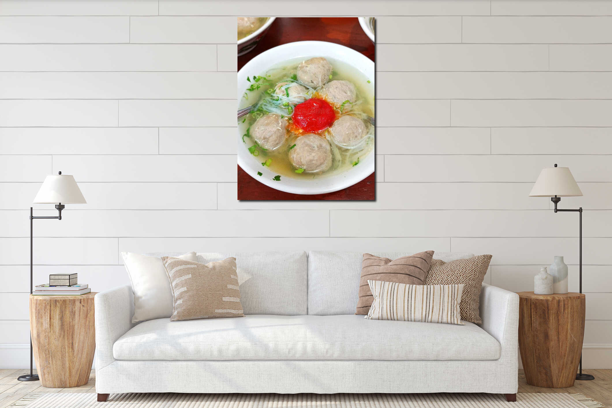 A bowl of beef meatball soup with clear, fresh broth, served hot and appetizing in a simple traditional style interior mockup
