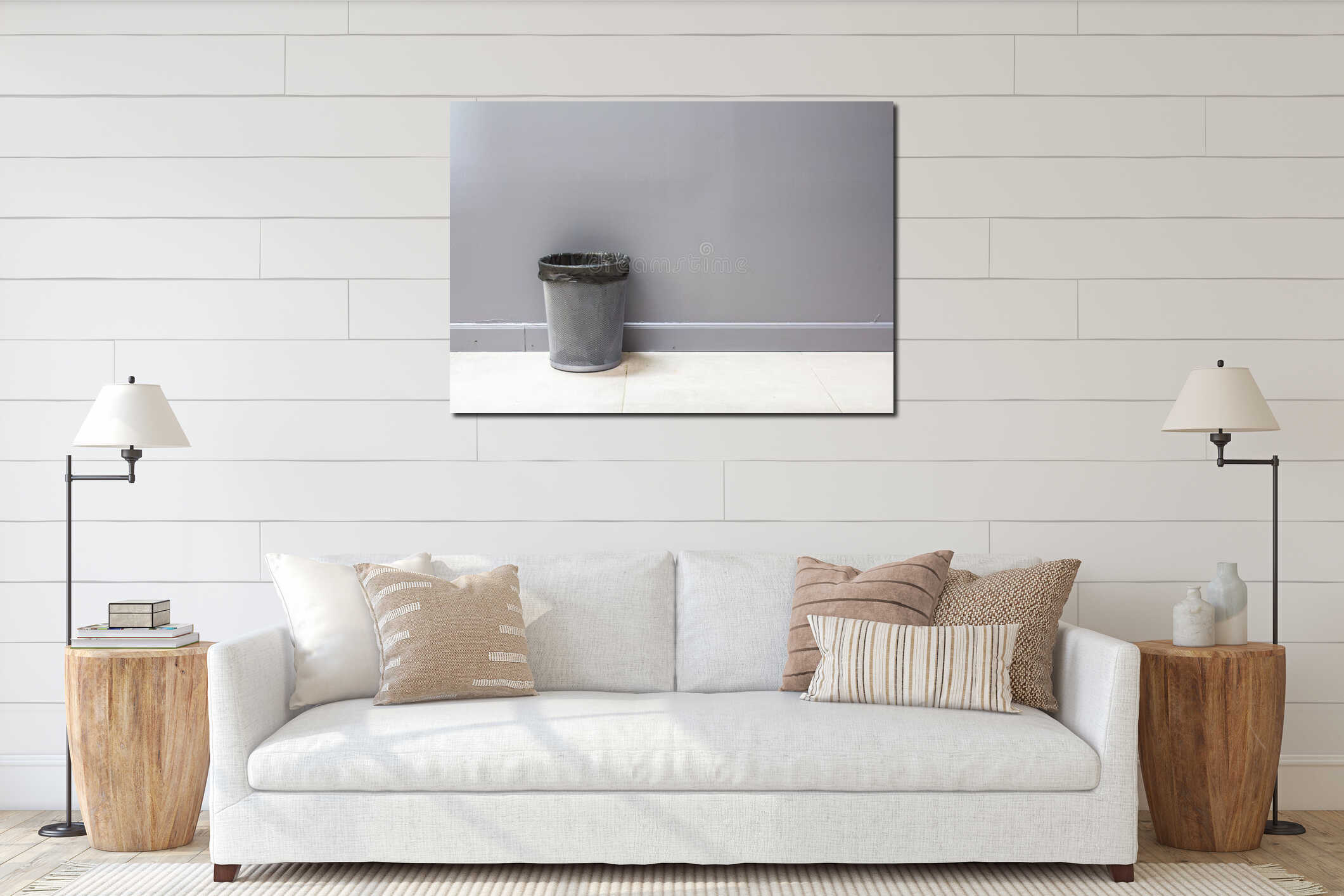 An empty metal trashcan (bin) isolated on gray interior mockup