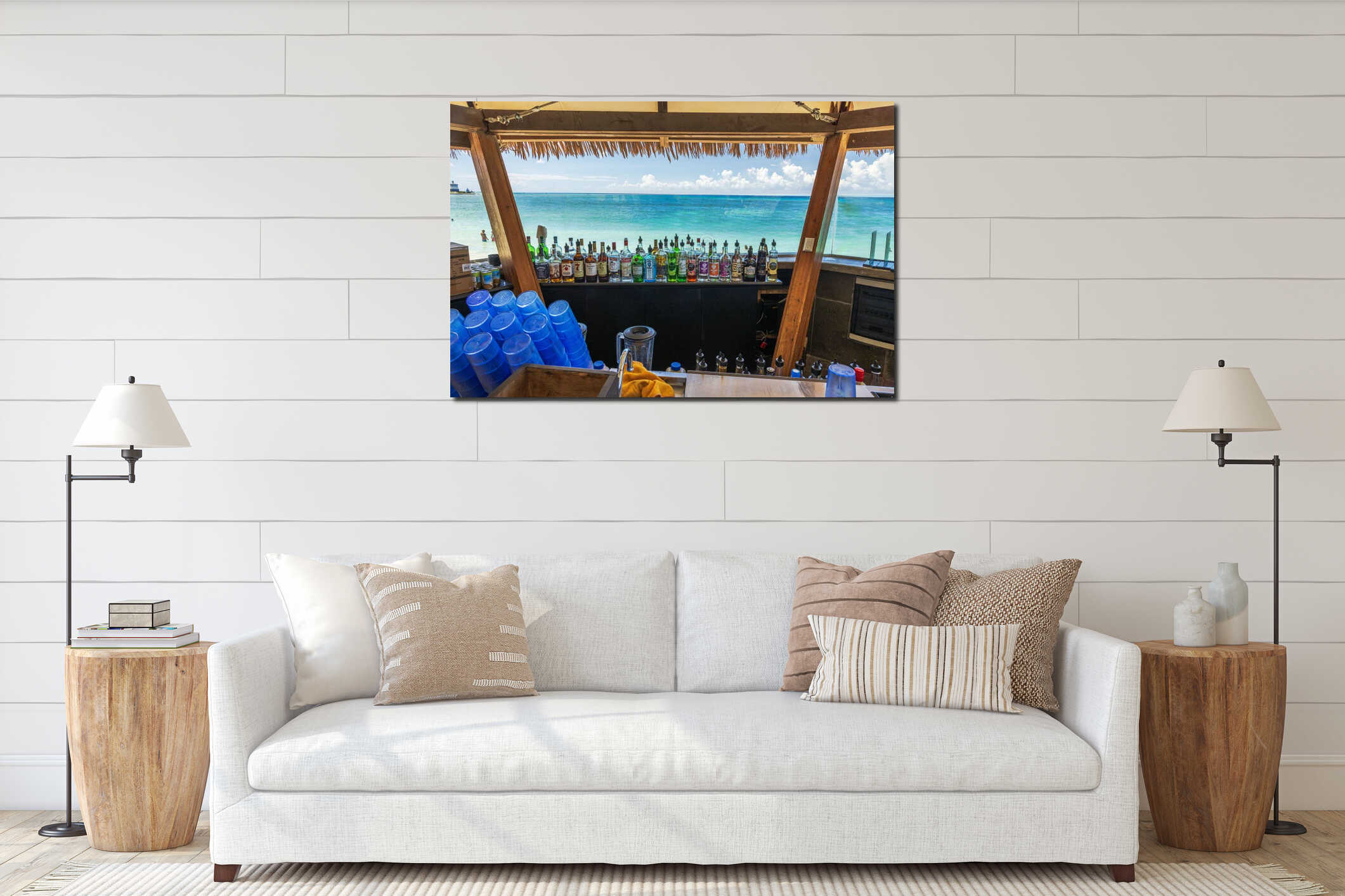 Tropical beach bar with colorful bottles of alcohol and blue cups on background of turquoise Caribbean Sea and bright sky. interior mockup